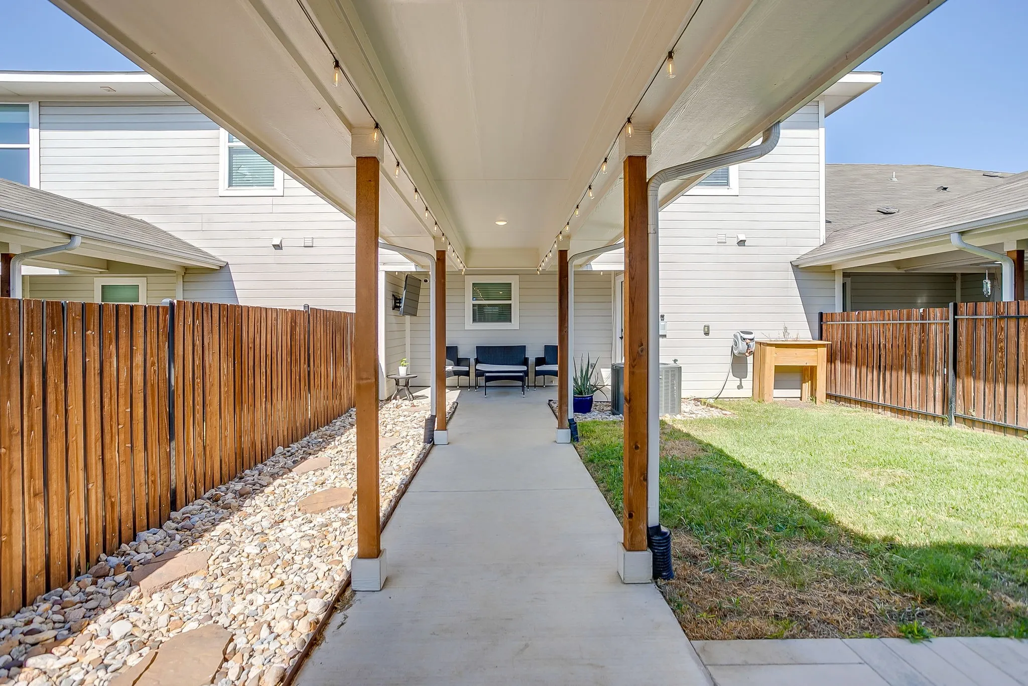 Covered patio with string lighting and concrete flooring