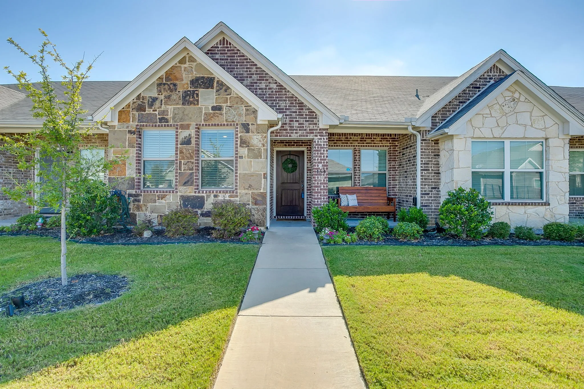 Brick and stone veneer exterior with gabled roof lines