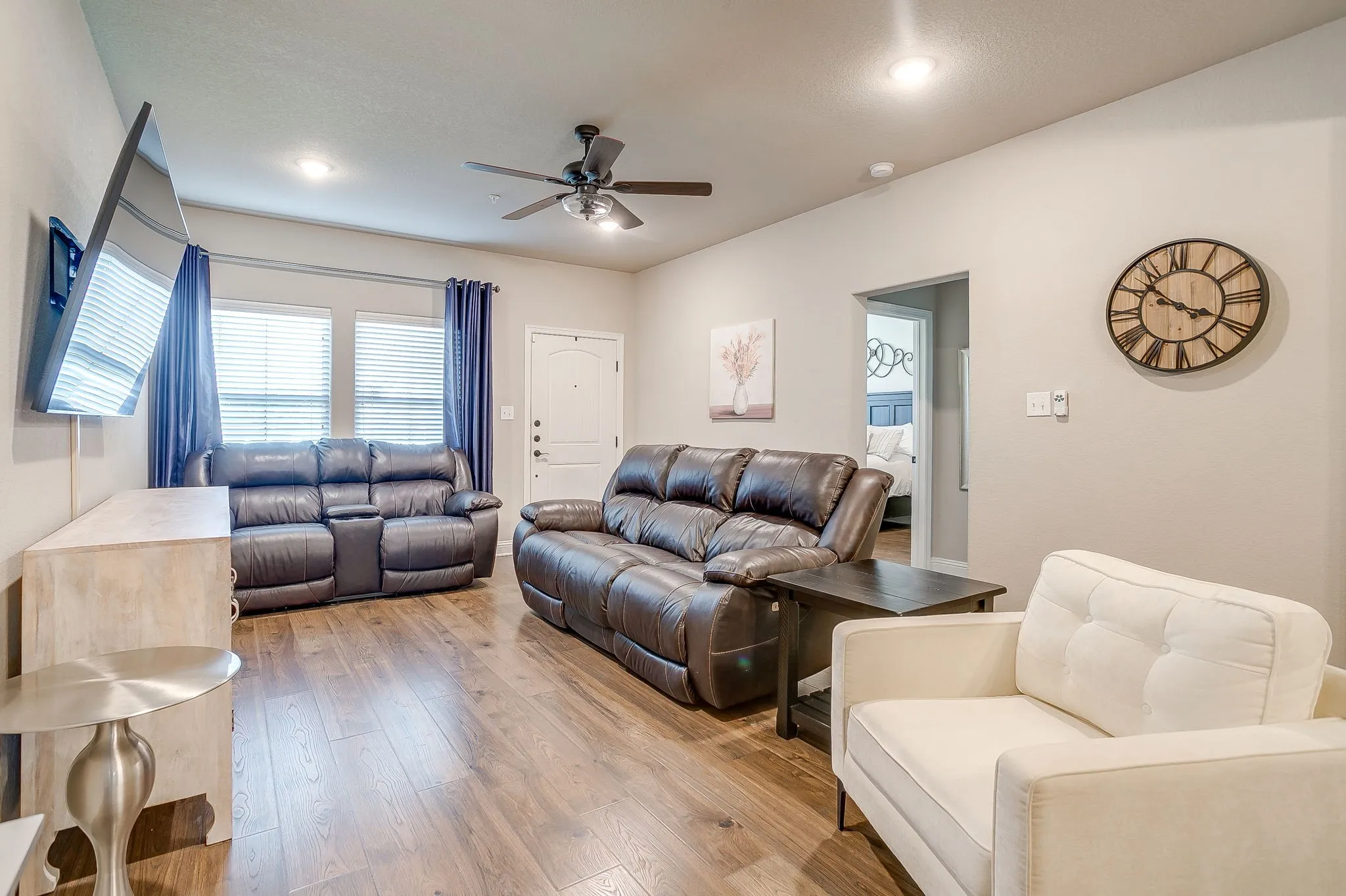 Open-concept living space featuring wood-finish flooring, recessed lighting, and a ceiling fan