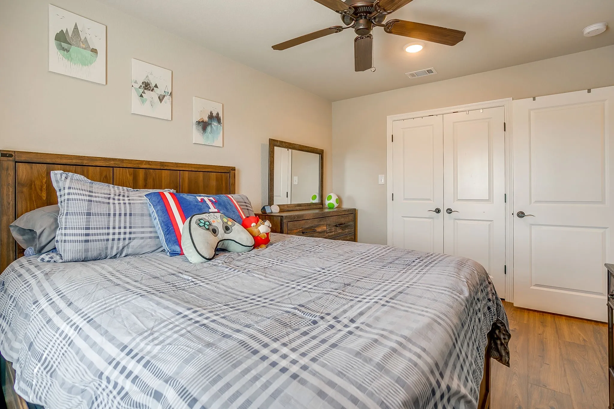 Bedroom featuring wood-finish flooring, a ceiling fan with integrated lighting, recessed lighting, and two sets of white bi-fold closet doors