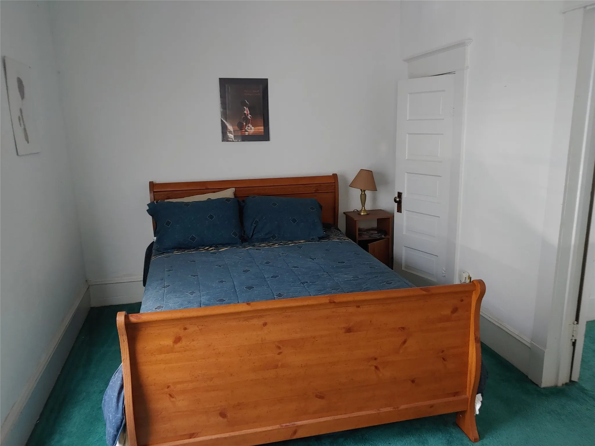 Room featuring white painted walls and trim, with a panel door