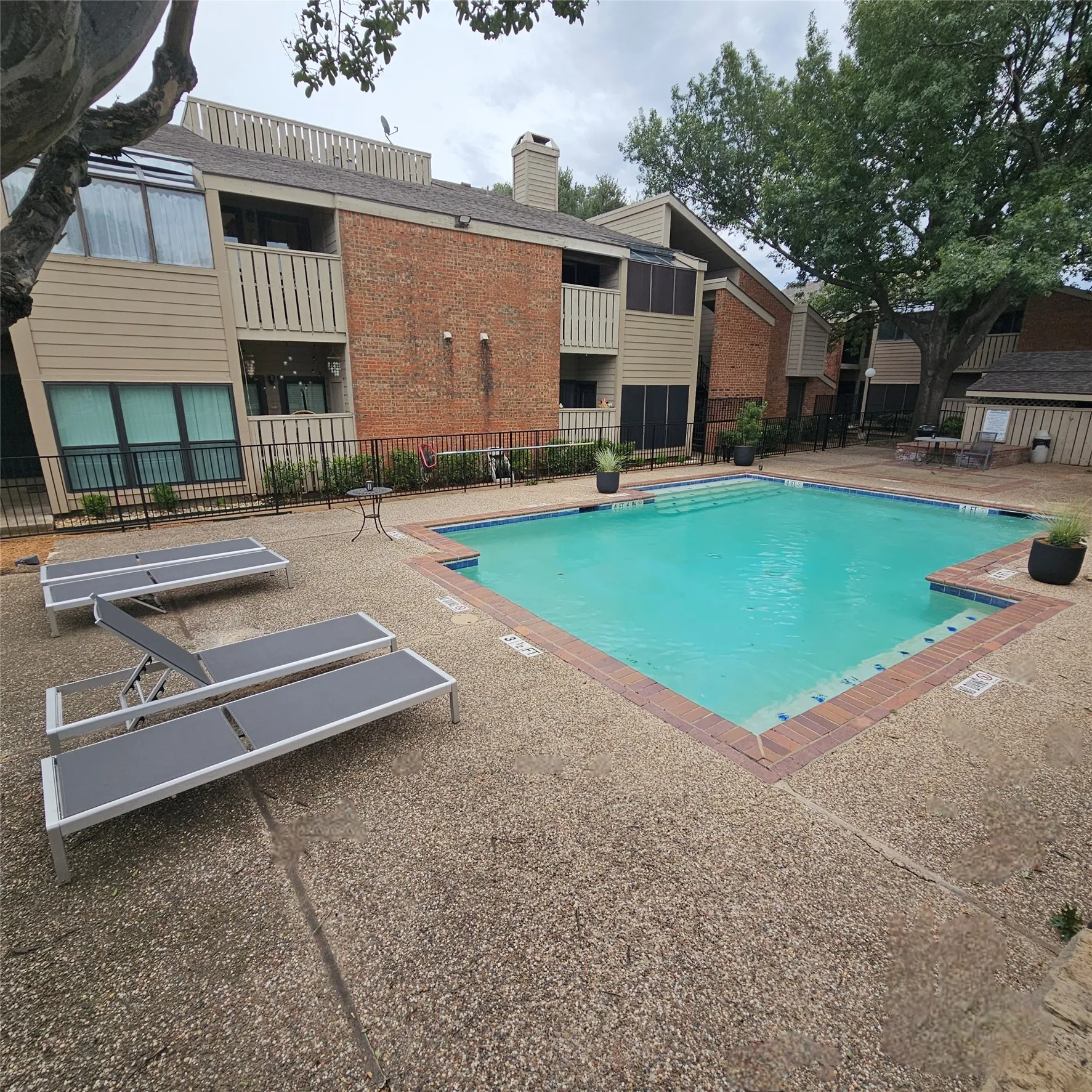 Community pool with a patio