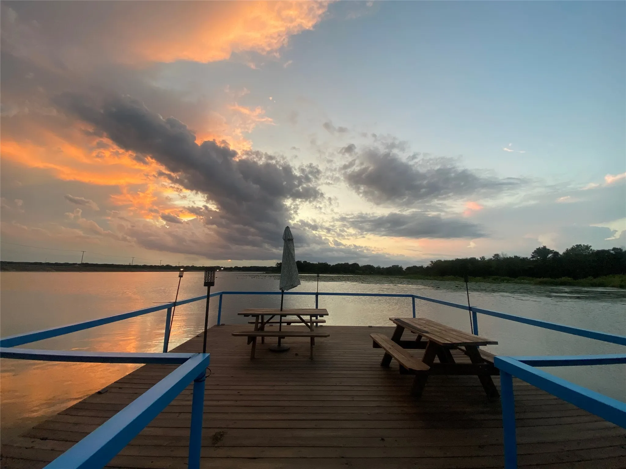 Wood-plank dock for your fishing and entertaining, two built-in picnic tables, and a serene waterfront setting