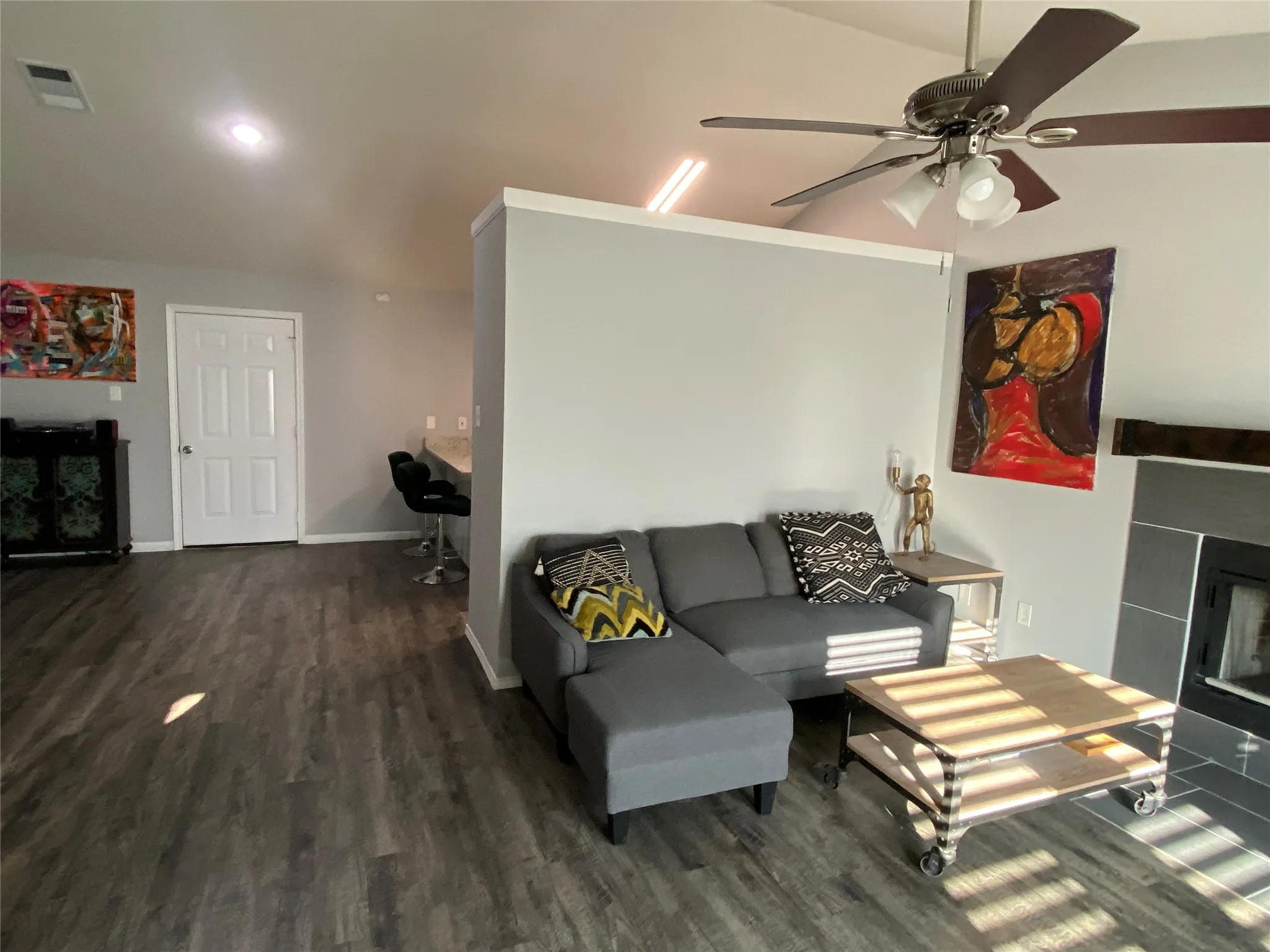 Spacious living area featuring wood-finish luxury vinyl plank flooring, ceiling fan, and recessed lighting
