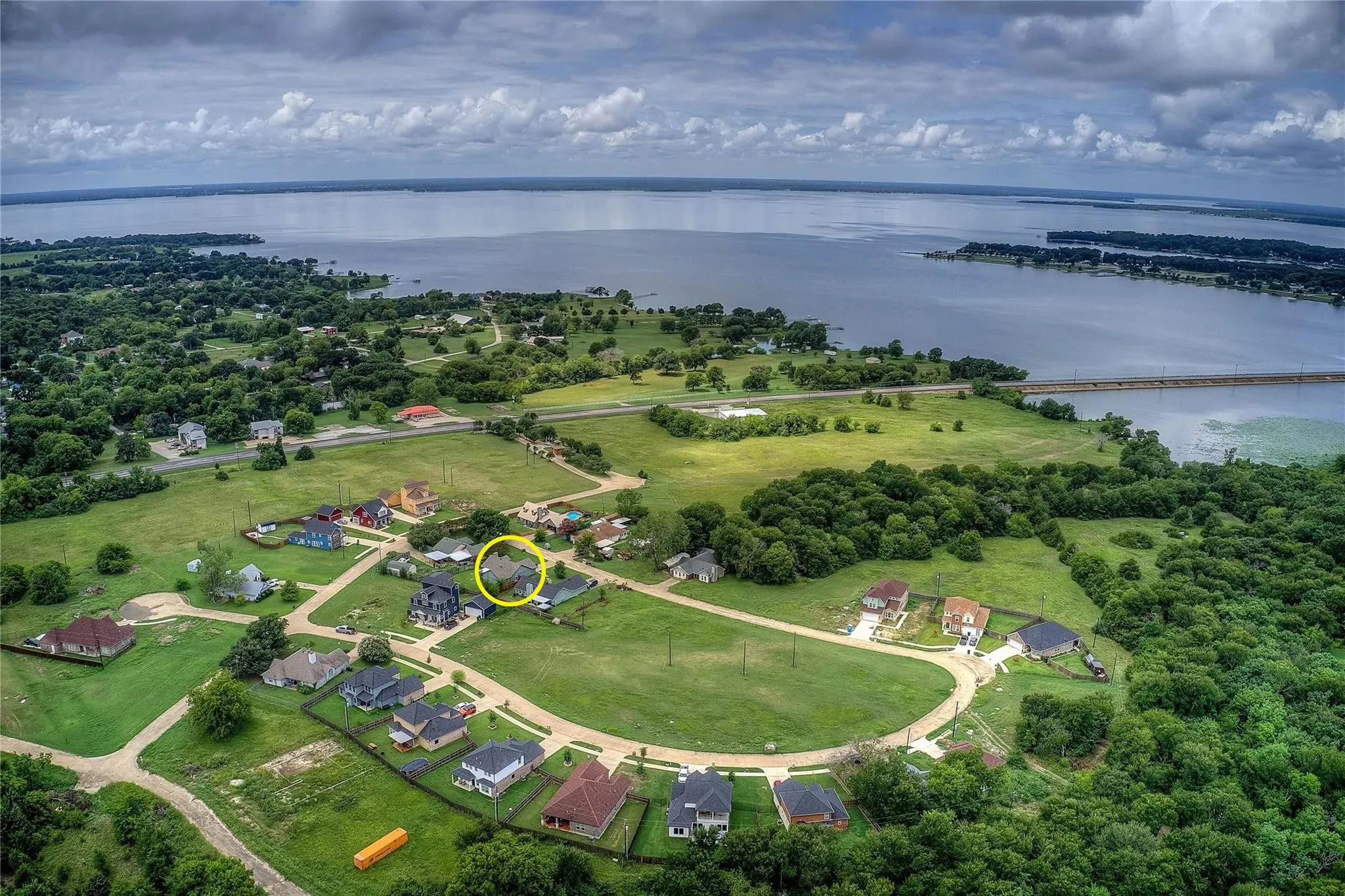 Aerial perspective showcasing the residential community with a waterfront backdrop