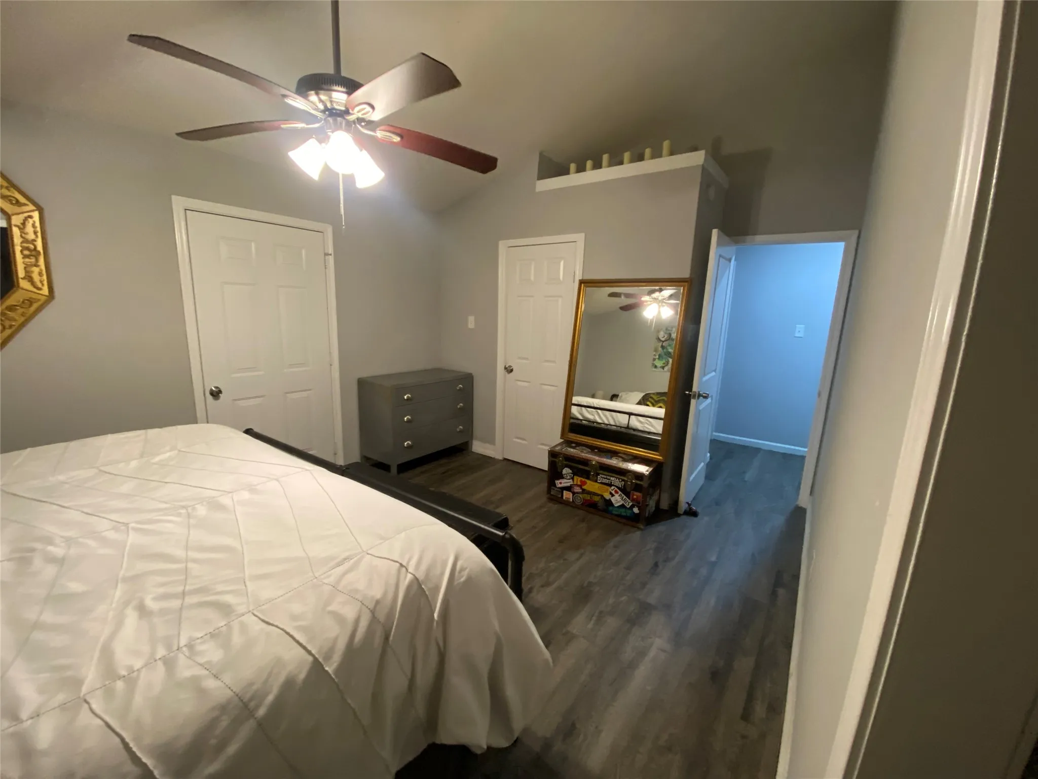 Vaulted ceiling in primary bedroom with access to back patio