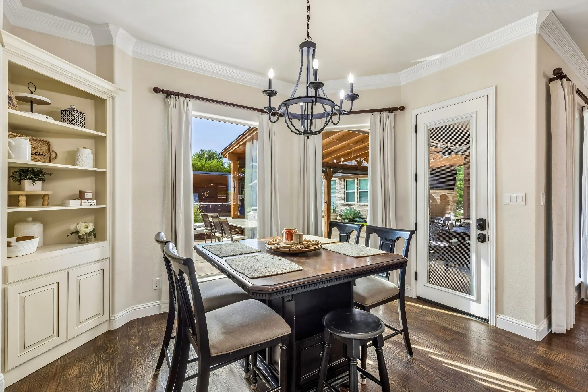 Built-in cabinetry with shelving, recessed lighting, wood-finish flooring, and crown molding