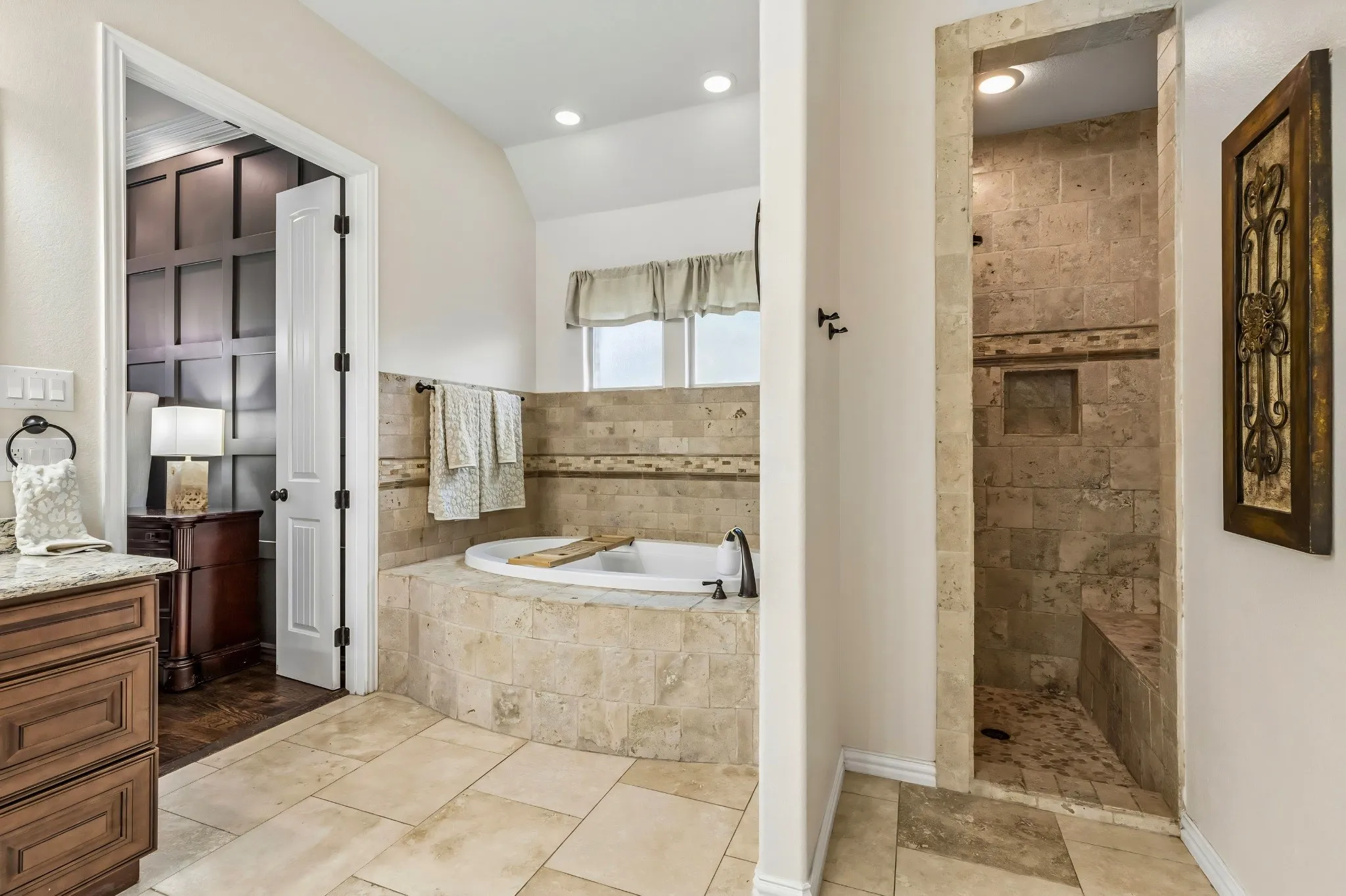 Tiled walk-in shower with built-in bench and niche