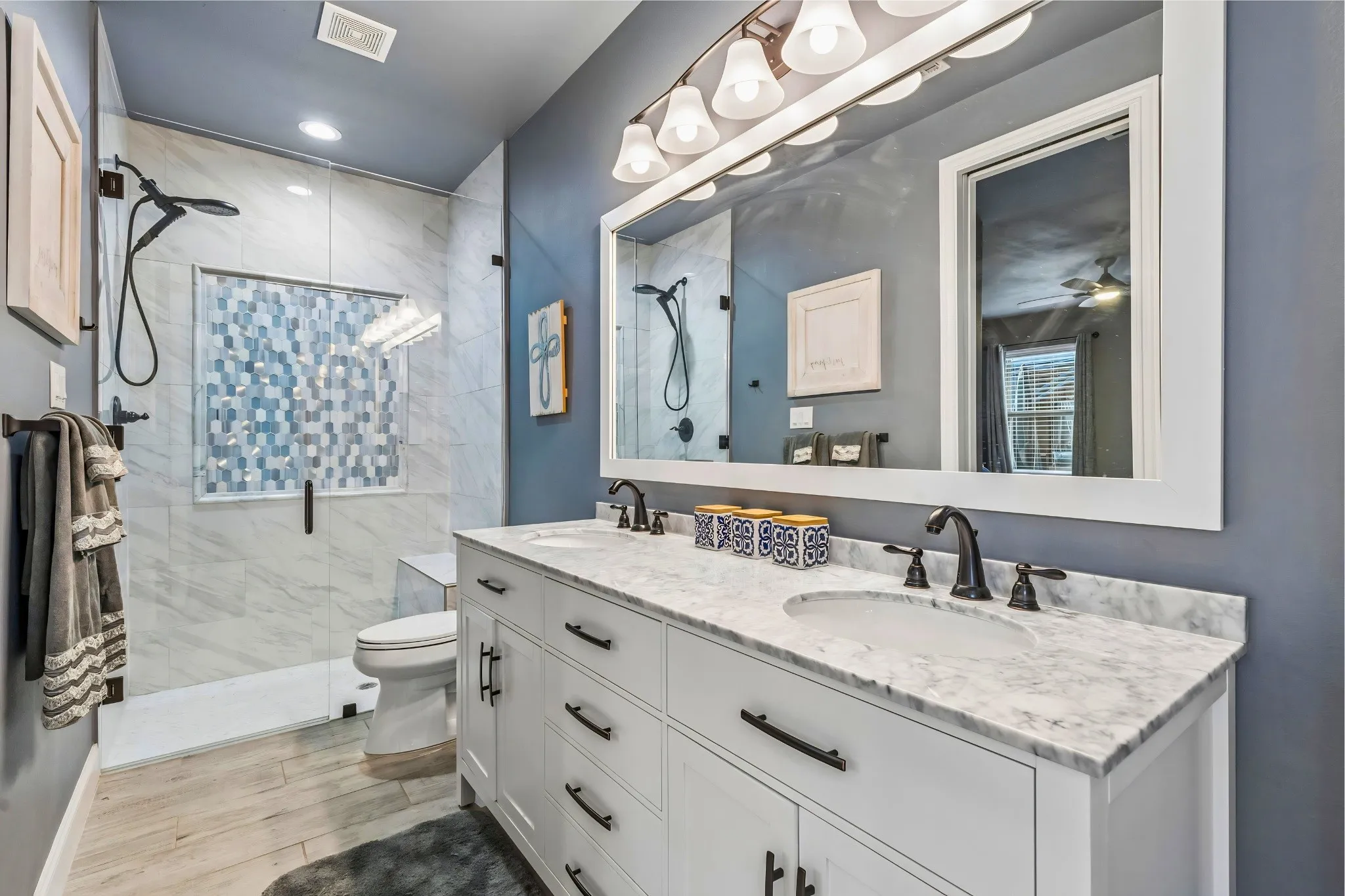 Dual vanity with white cabinetry and dark hardware
