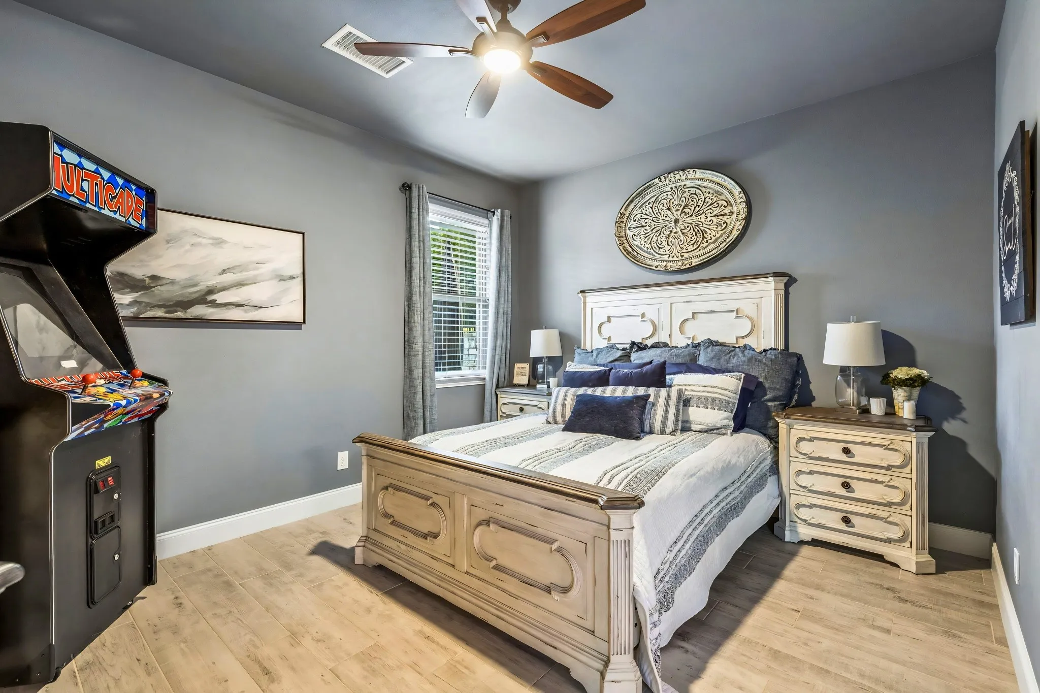 Wood-finish flooring with a ceiling fan featuring a light fixture