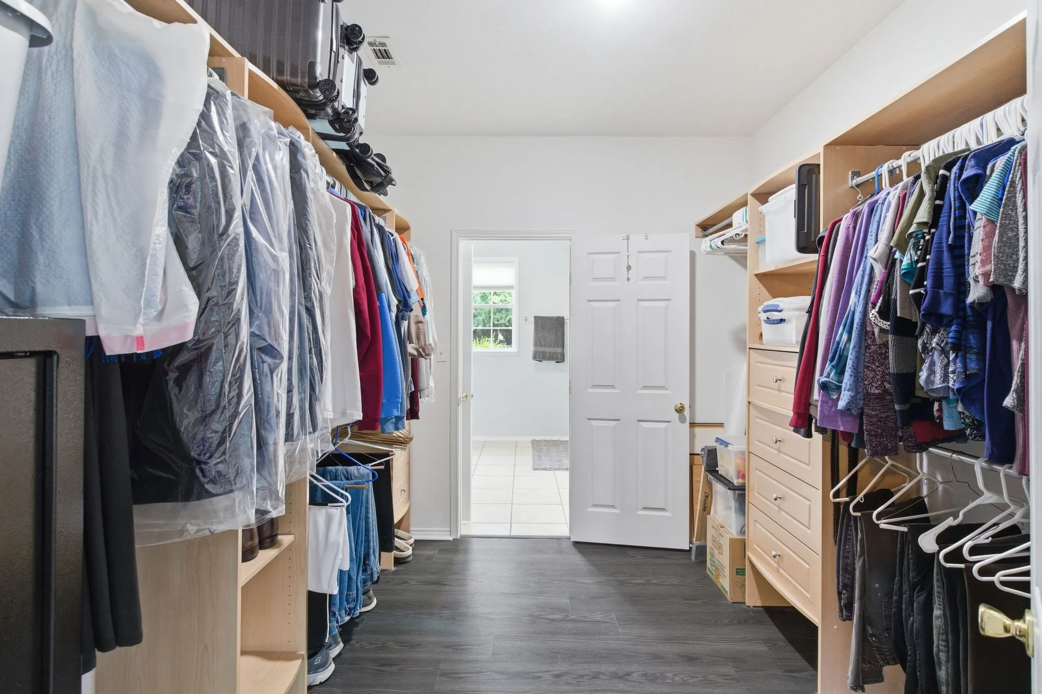 Walk-thru closet connects primary bed to bath
