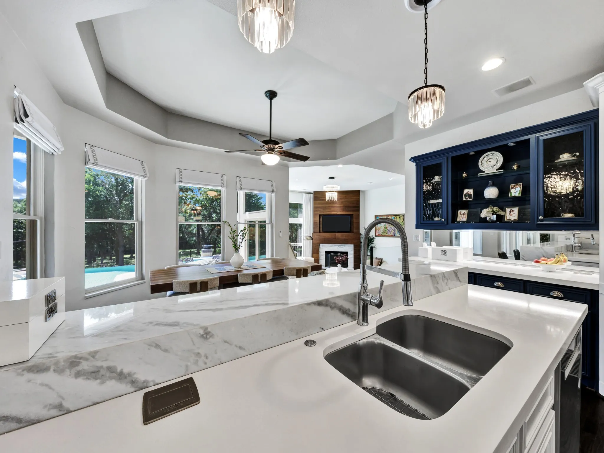 Kitchen island with a double basin stainless steel sink and a gooseneck faucet