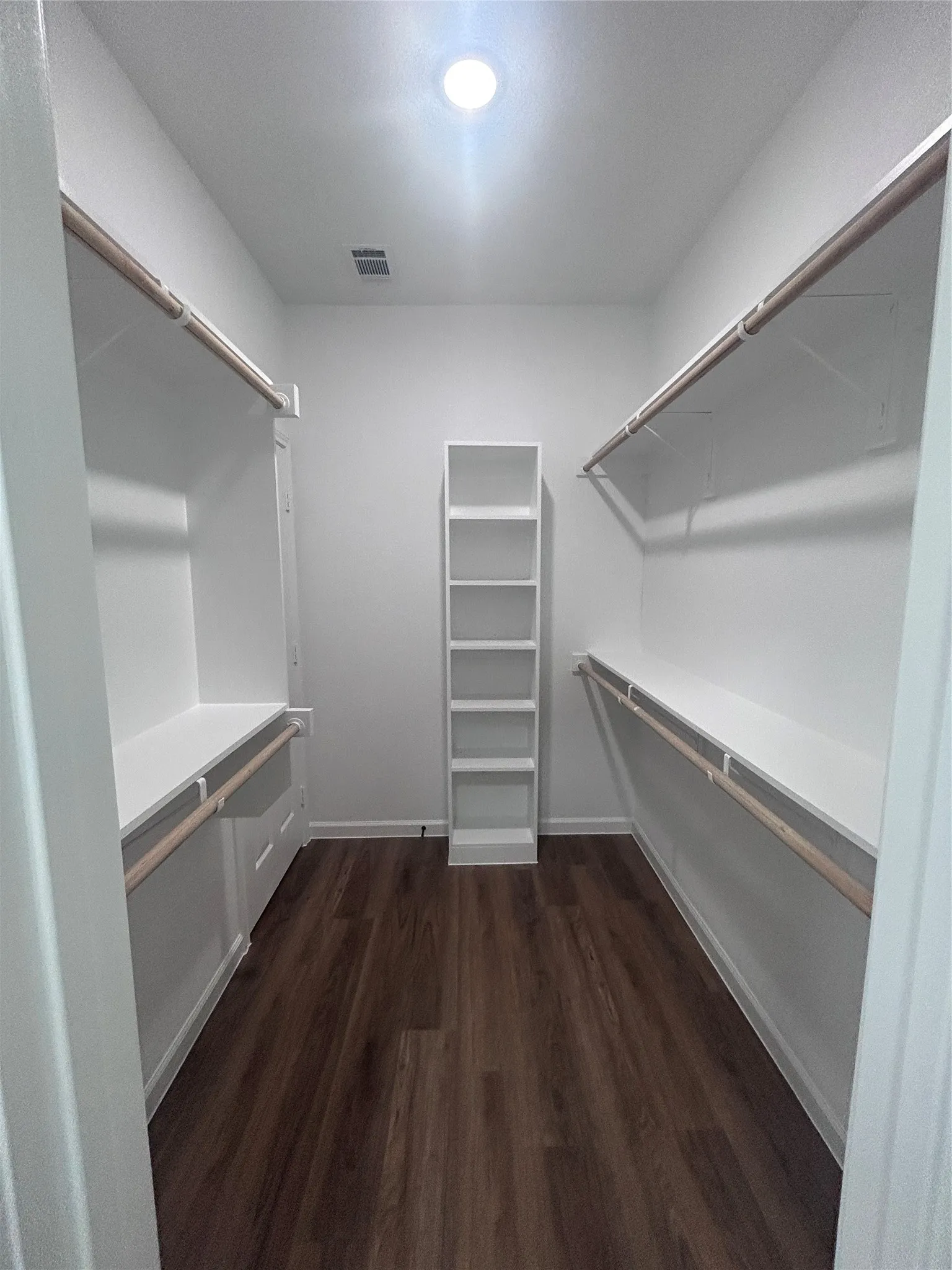 Primary closet that leads to laundry room