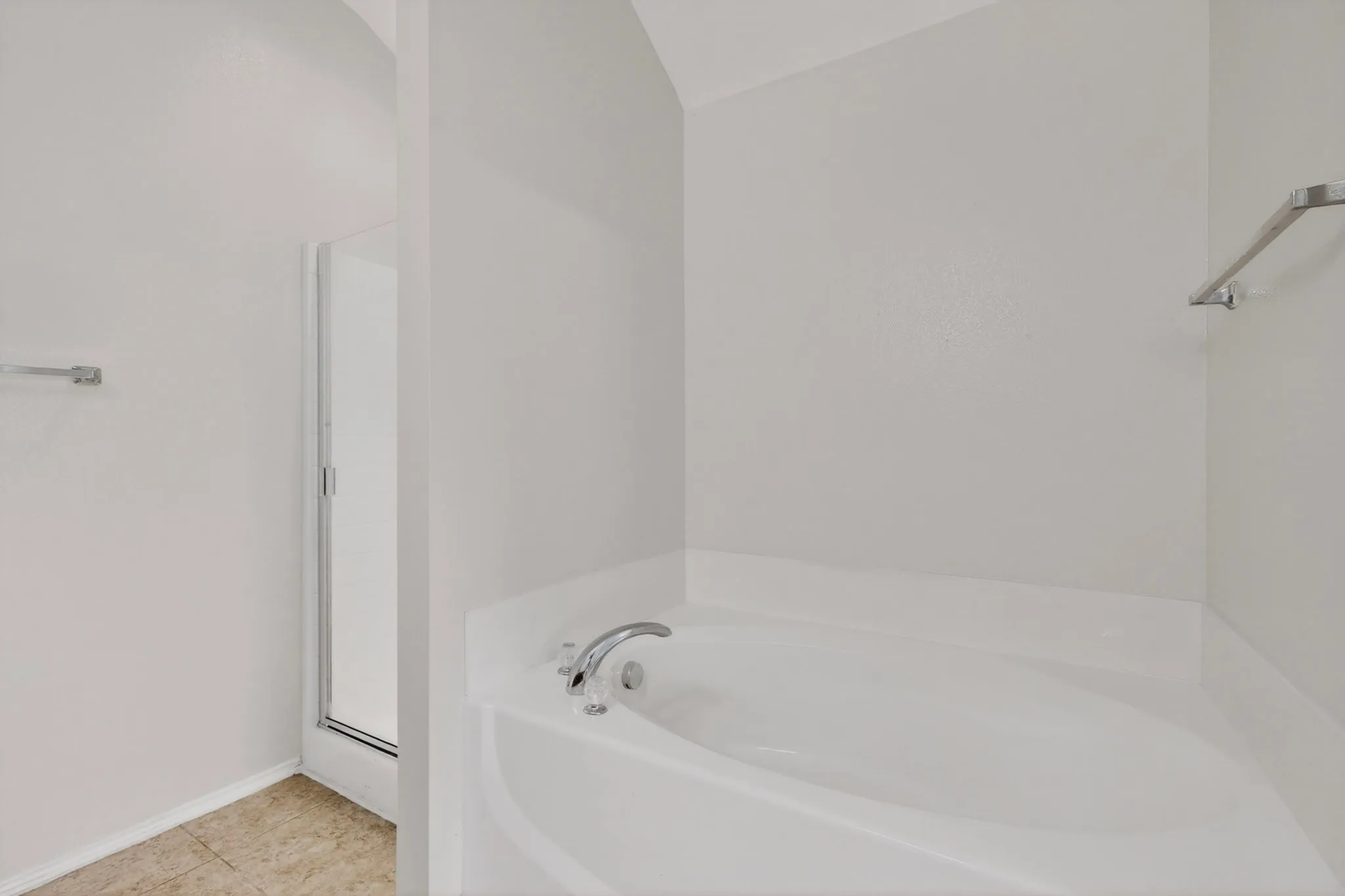 Built-in soaking tub with chrome fixtures, glass-enclosed shower, and neutral wall paint