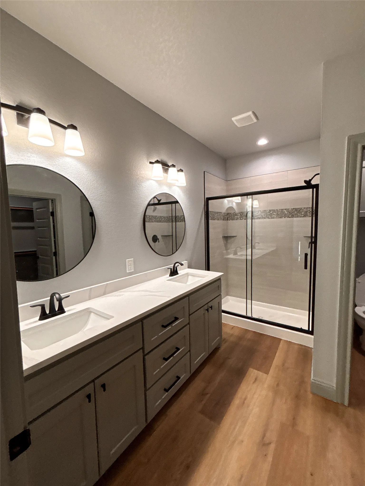 Dual vanity with white undermount sinks, stone-finish countertop, and matte black faucets