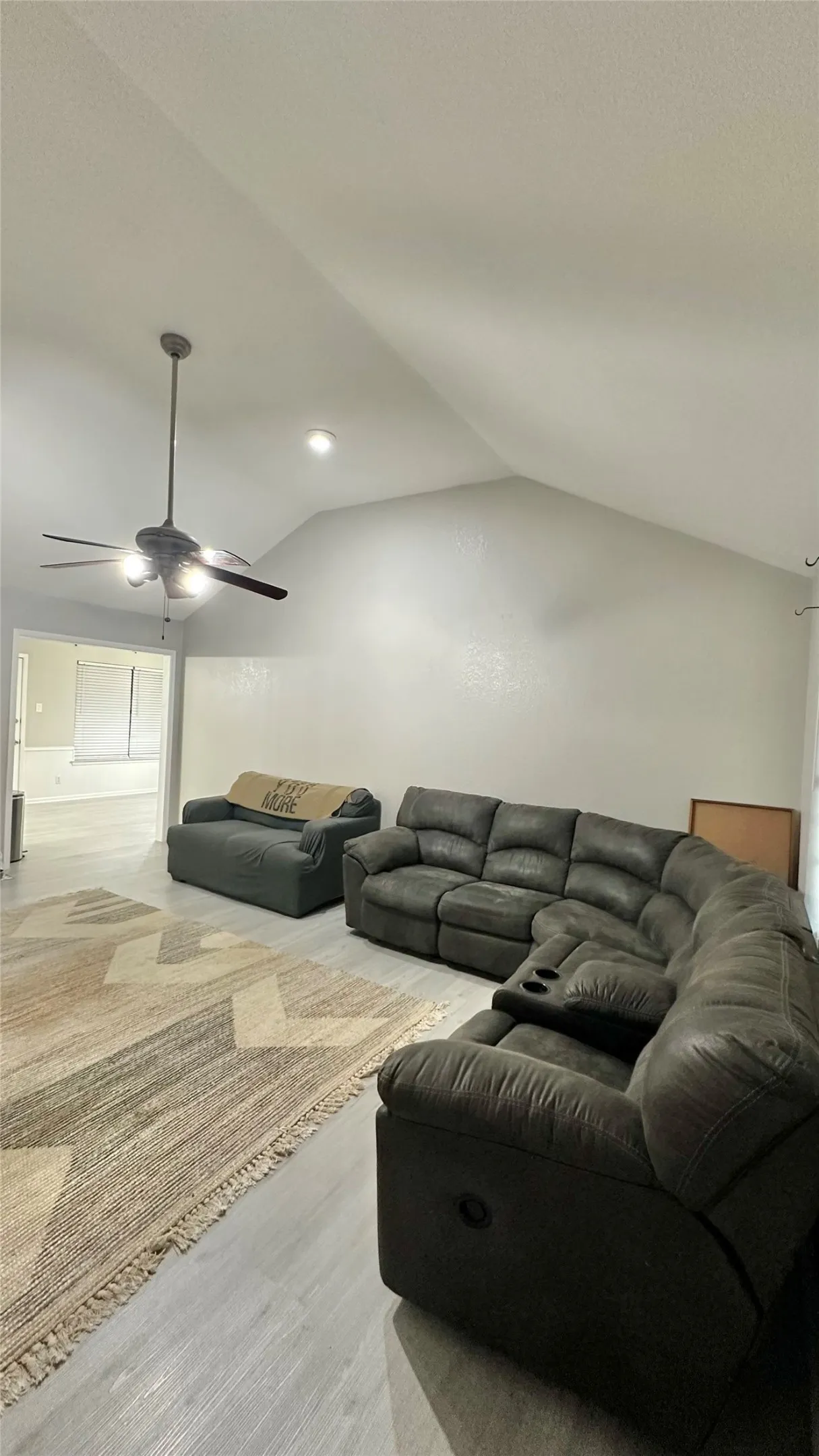 Vaulted ceiling with a ceiling fan and recessed lighting
