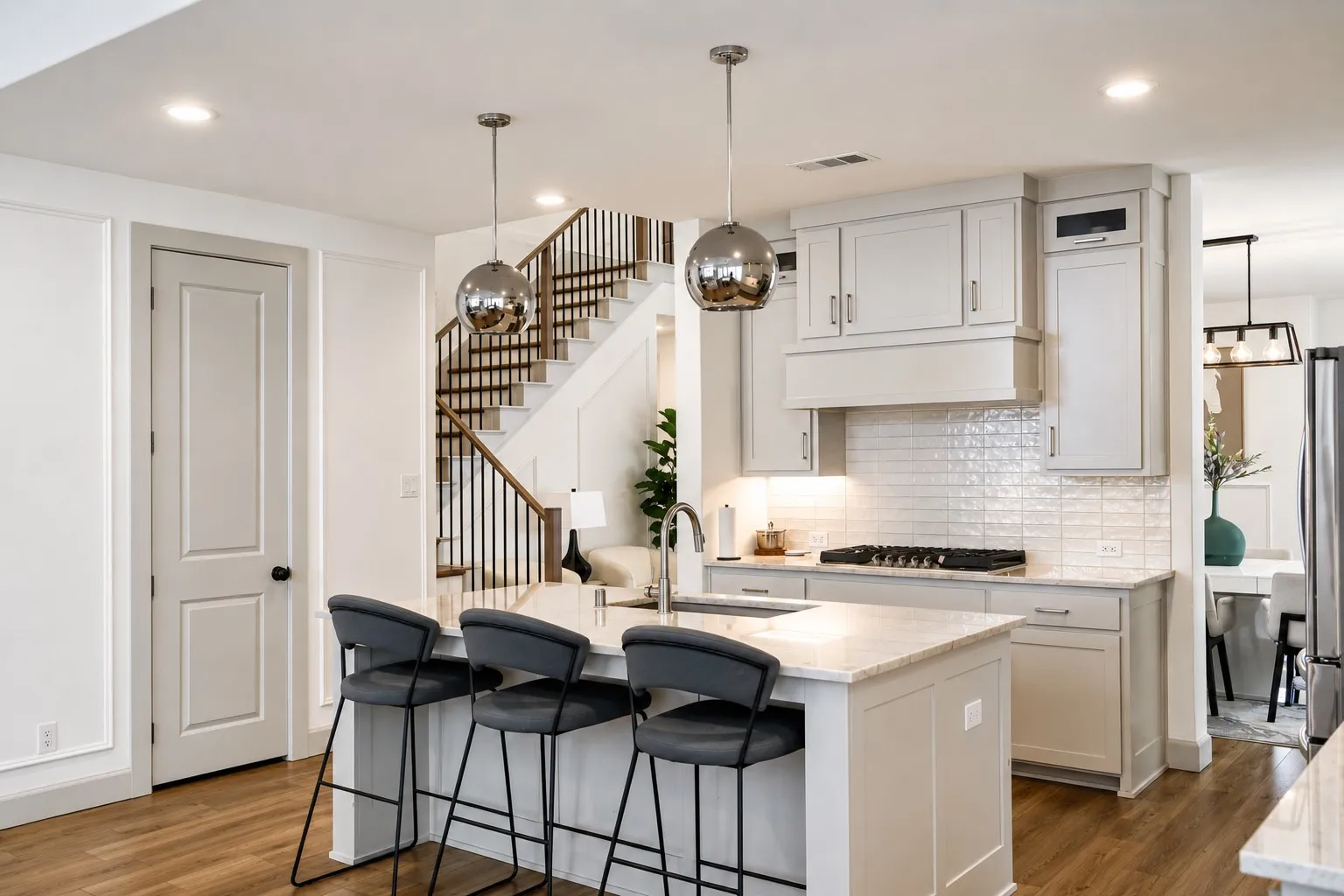 Kitchen featuring light-toned cabinetry, a gas range with a tile backsplash, and a central island with a stone countertop