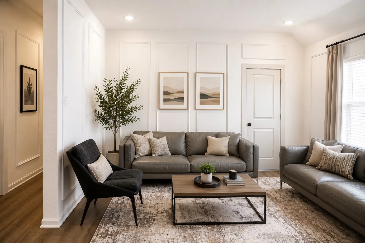 Living area featuring wainscoting panel accent walls and wood-finish flooring