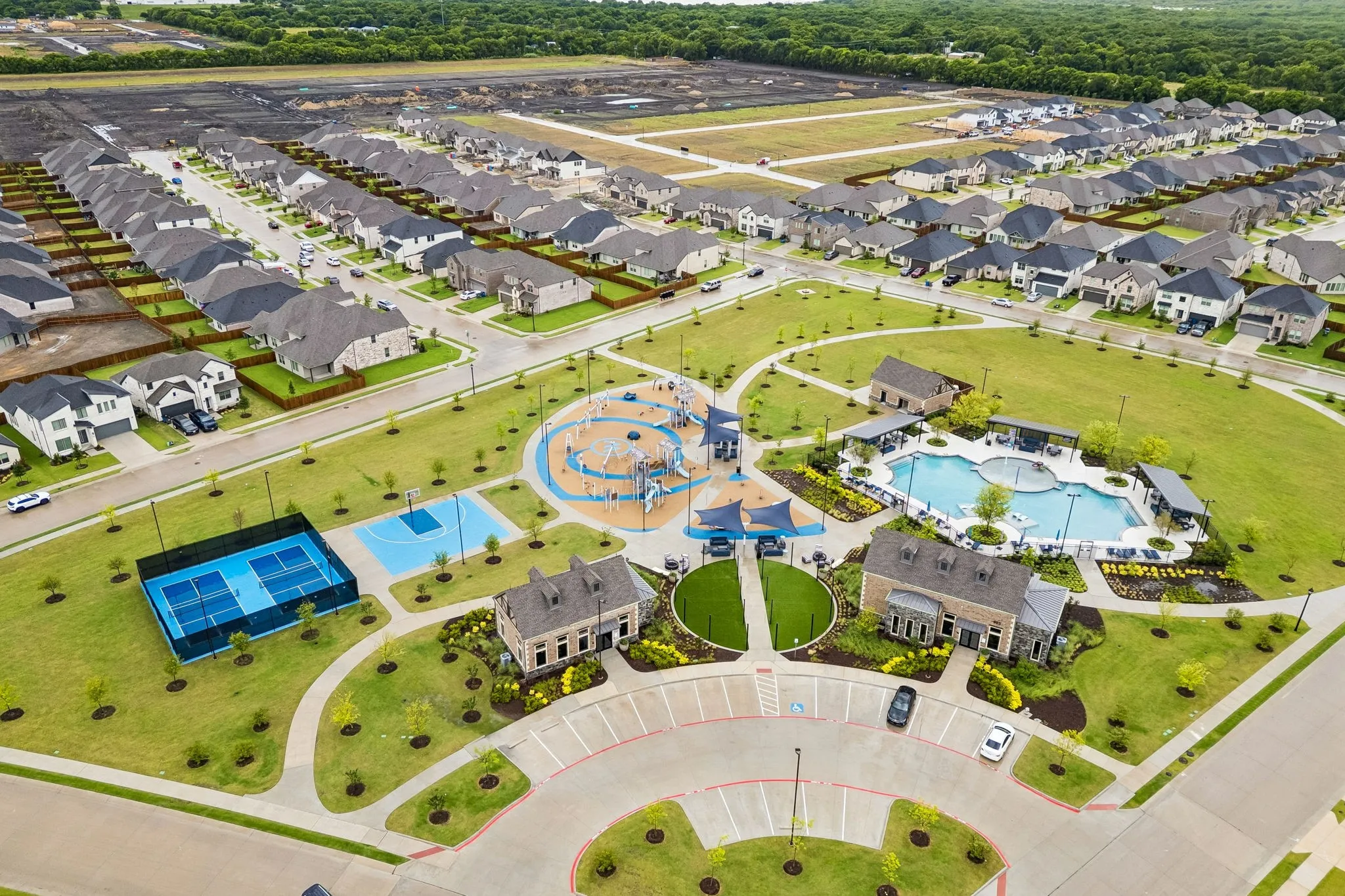 Community center with pickleball courts, basketball court, playground, community pool, and club house