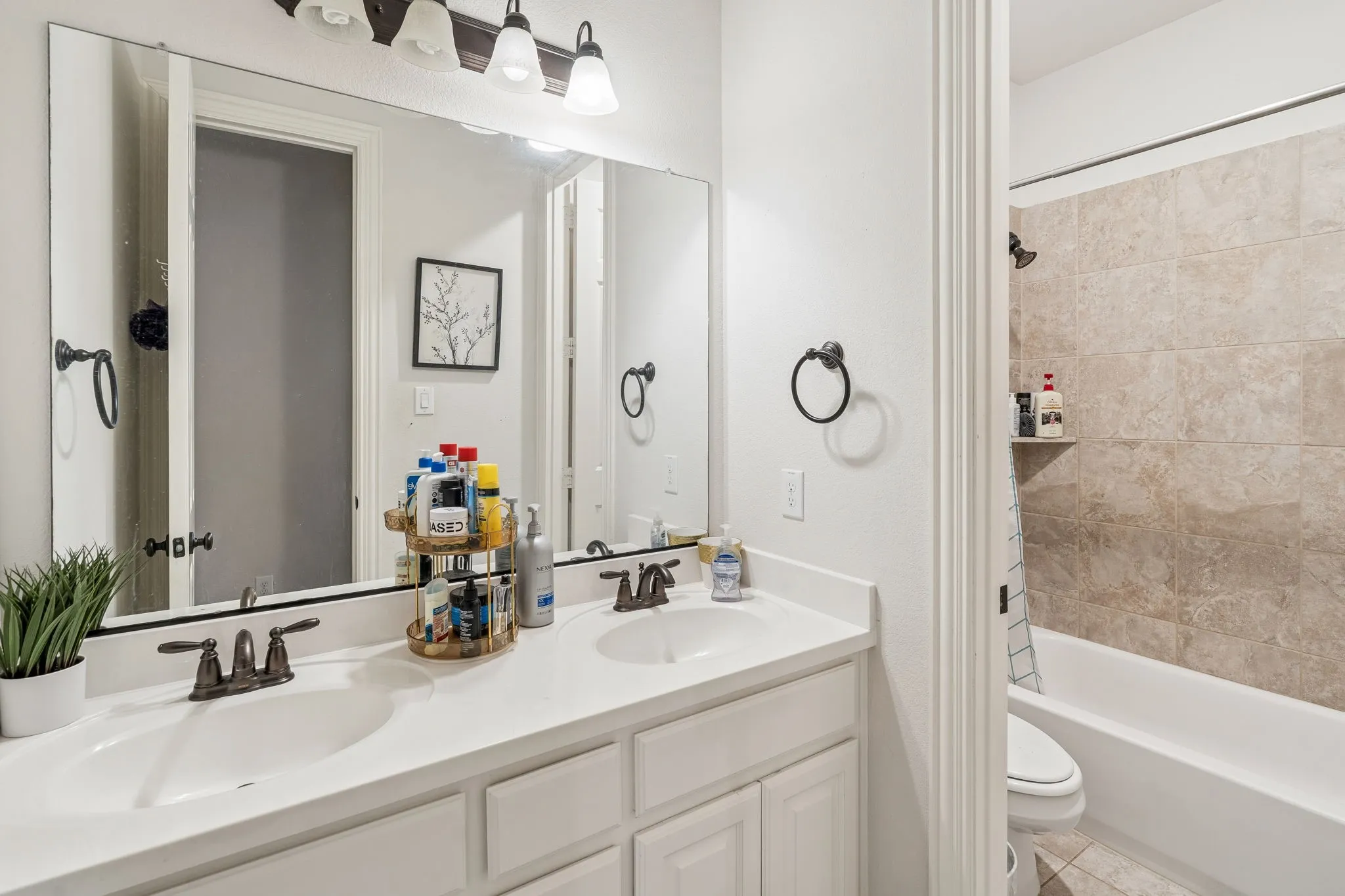 Dual undermount sinks set into a white countertop, framed by white cabinetry