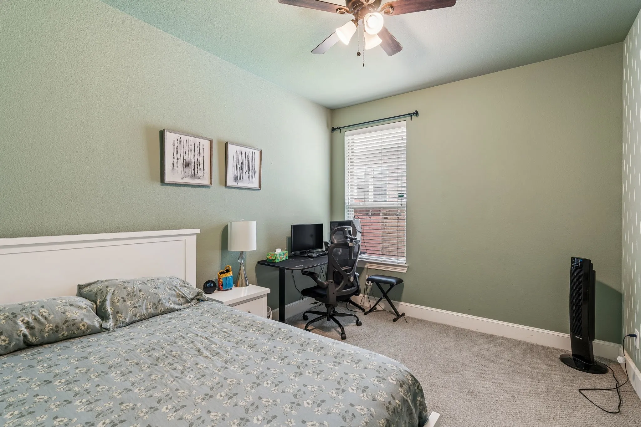 Bedroom featuring textured walls and soft carpet flooring