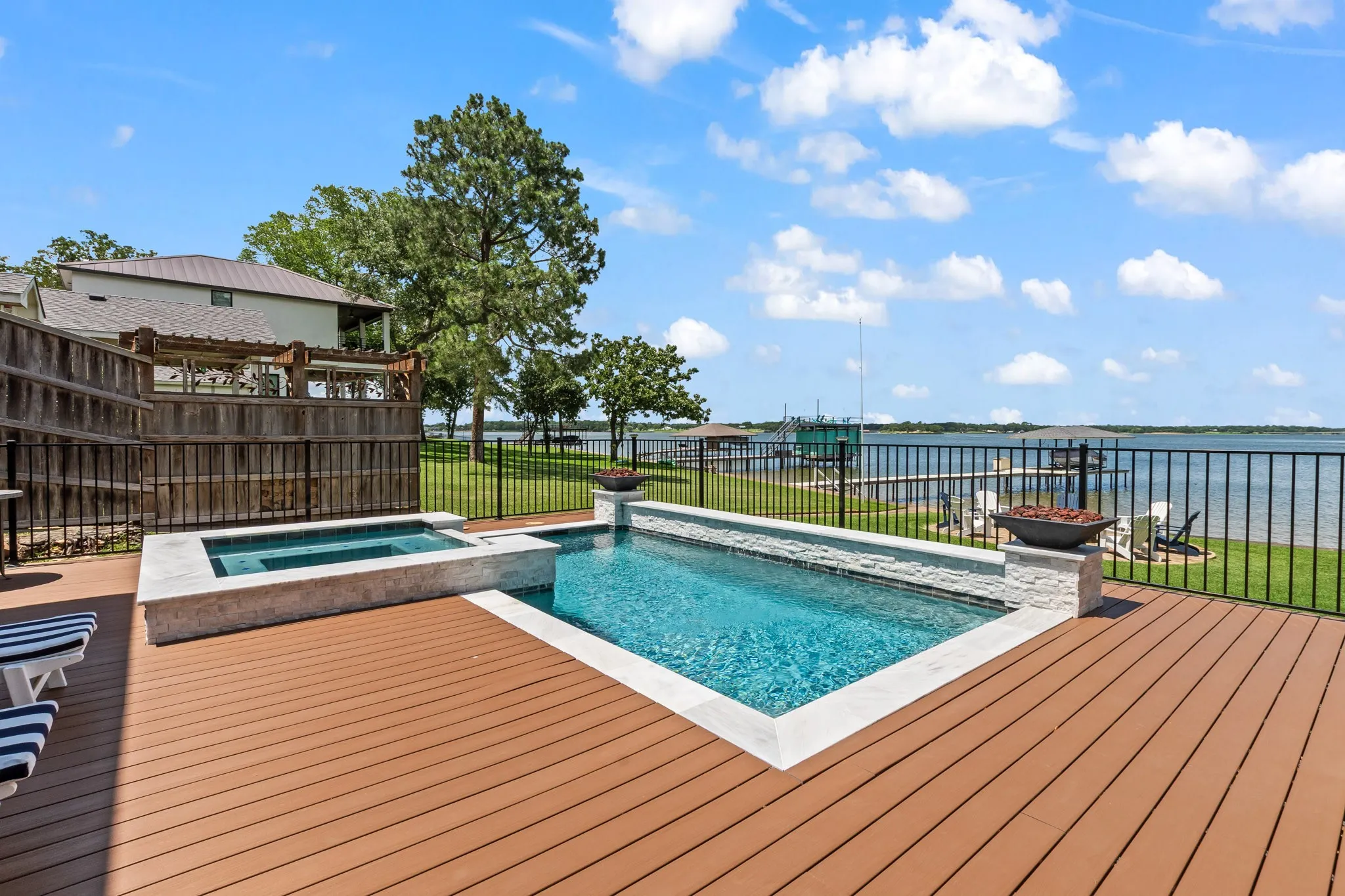 Expansive composite deck surround plus wrought iron fencing.