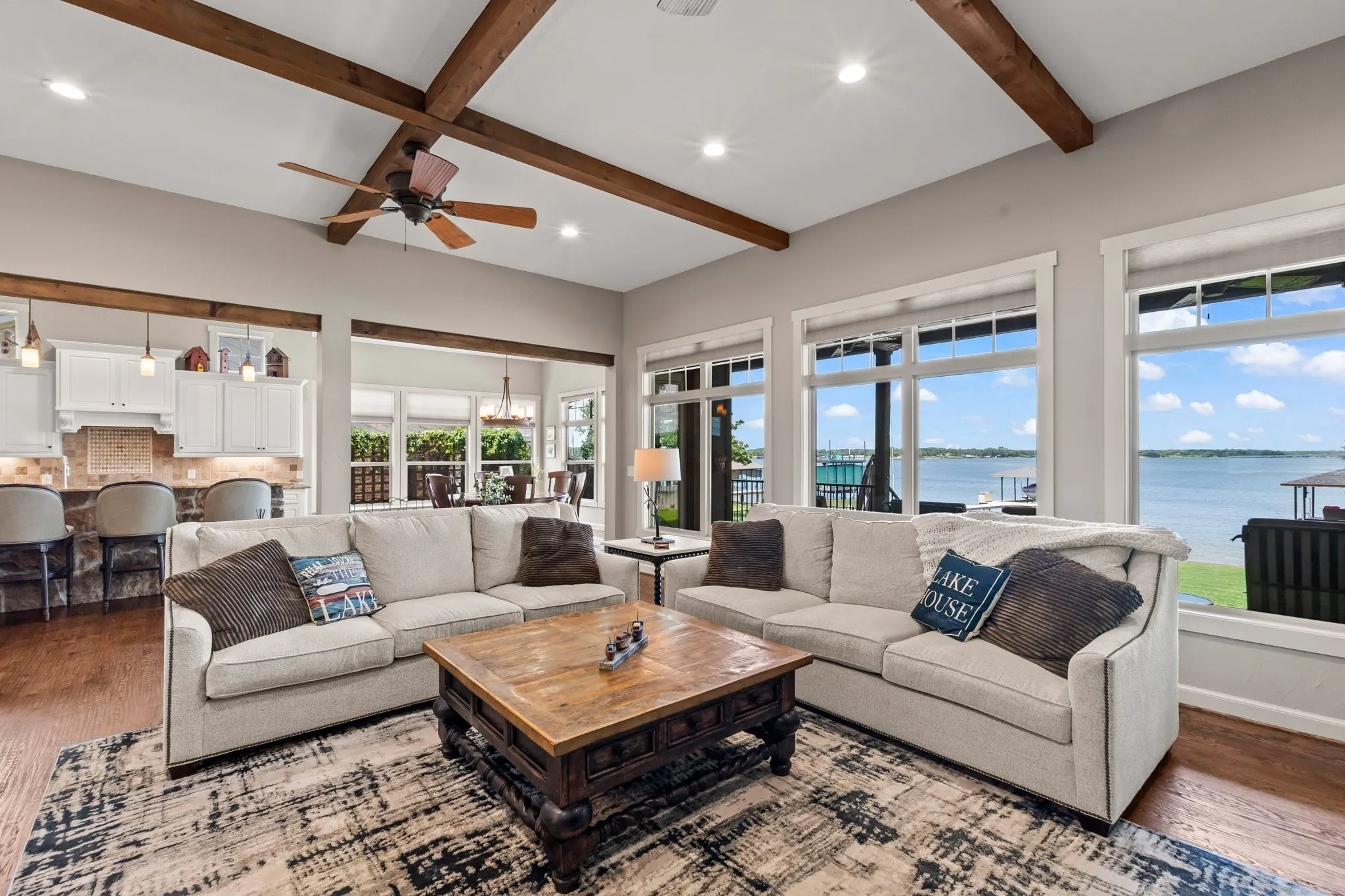 Hand-scraped wood floors, wood beams, stone accents add to the charm. New windows installed in 2024 showcasing the open-water views.