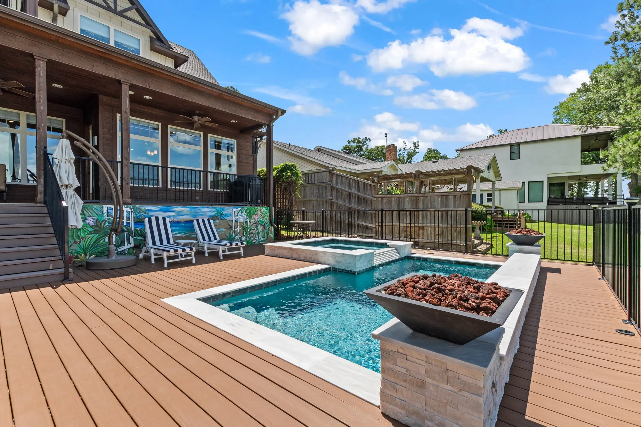 Enjoy lake life year round with the heated pool and spa framed by fire features and open water views.
