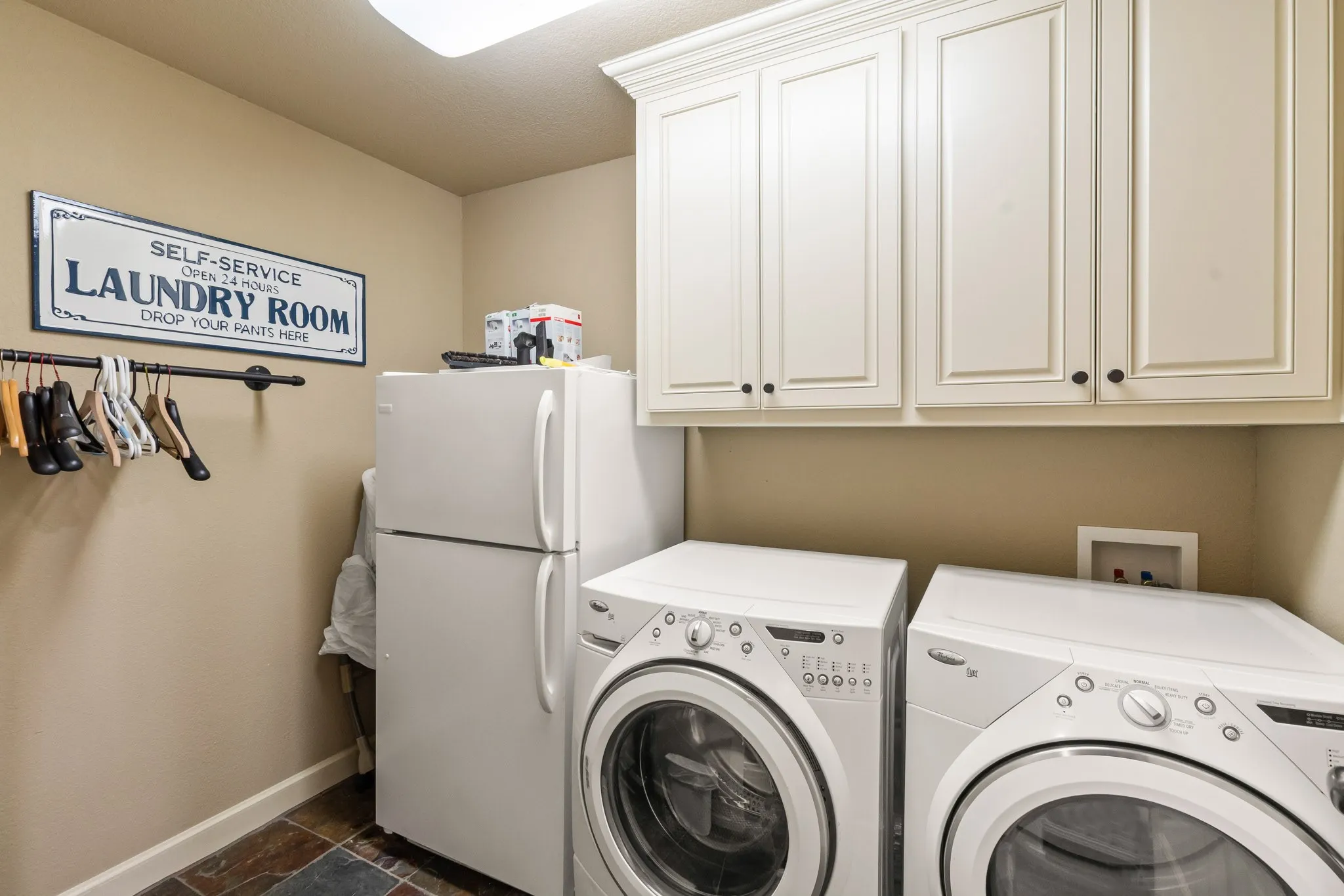 Large utility room with extra fridge.