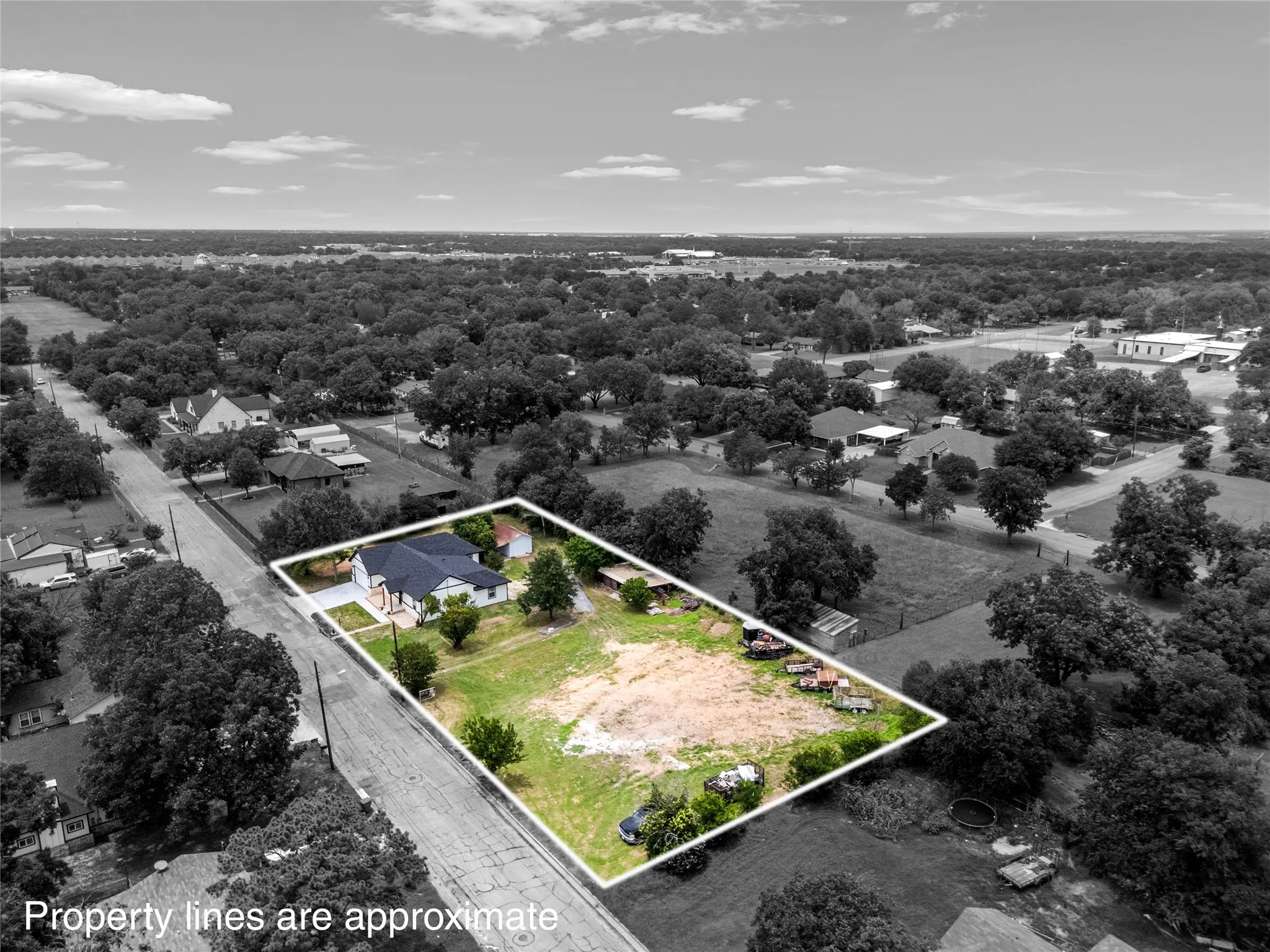Aerial perspective showcasing a single-story residence with a dark roof