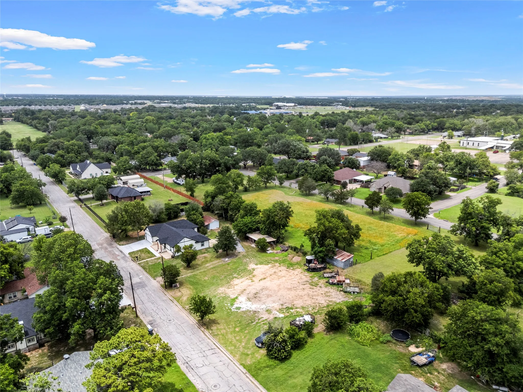 Aerial perspective showcasing a residential area characterized by mature trees and varied lot sizes