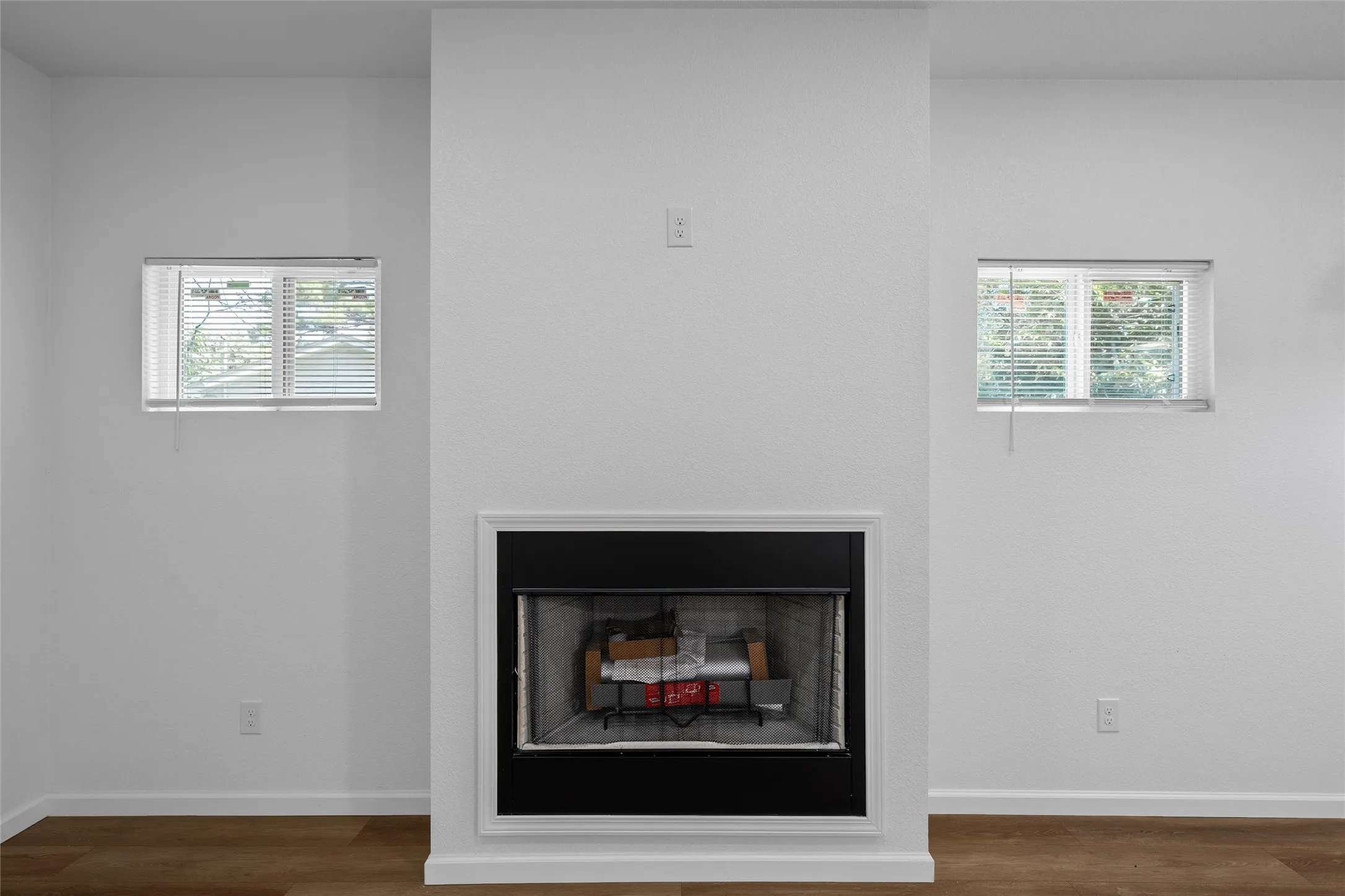 Central fireplace with a black surround and white trim
