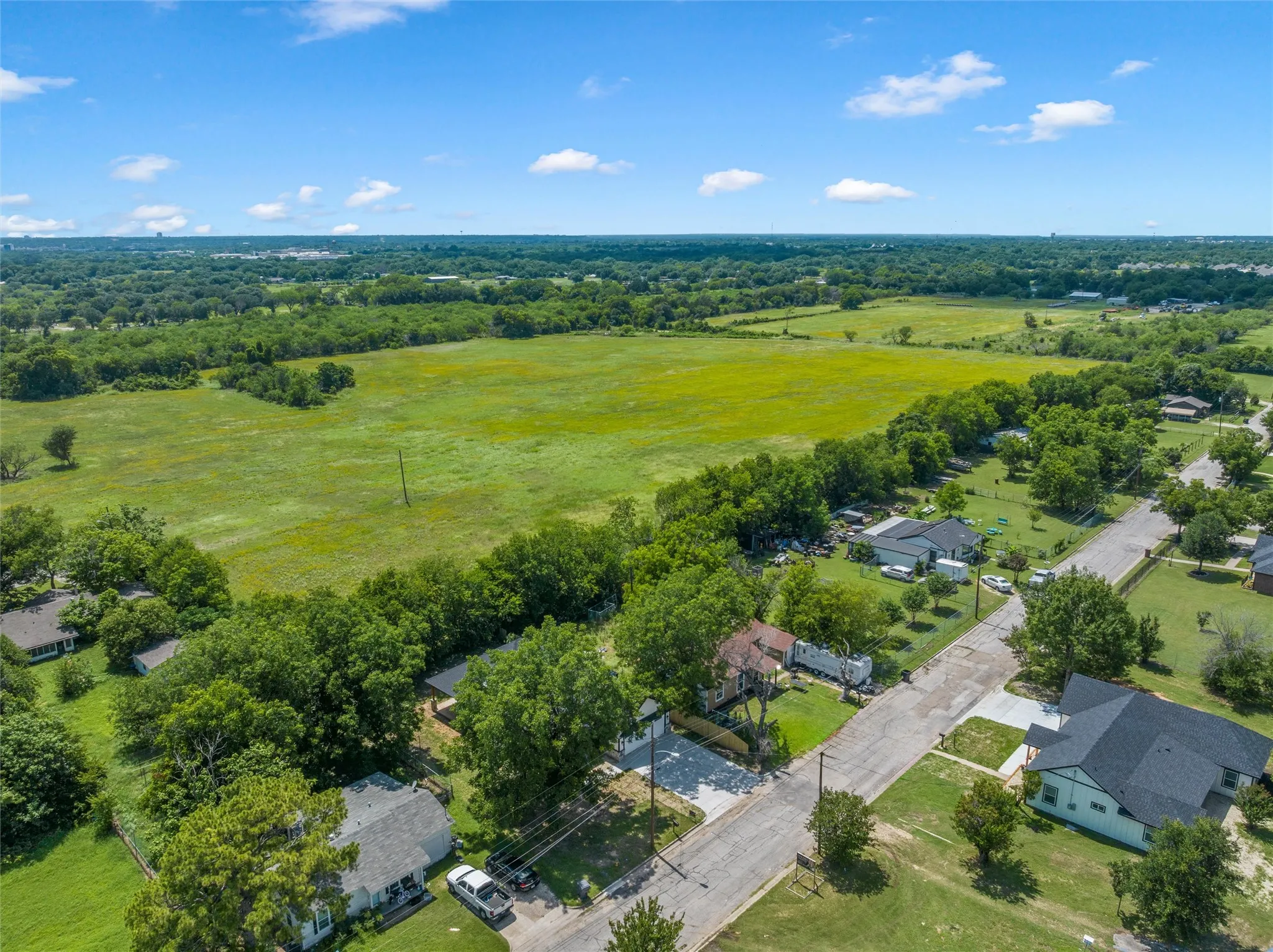 Expansive green space and surrounding wooded areas