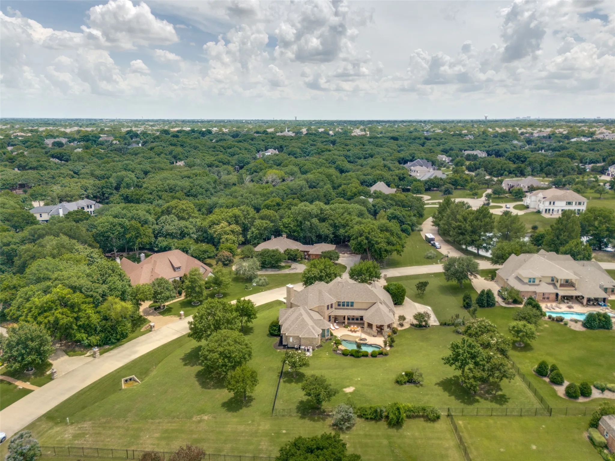 Spacious property featuring a large residence, expansive green lawn, private swimming pool, and dedicated patio space