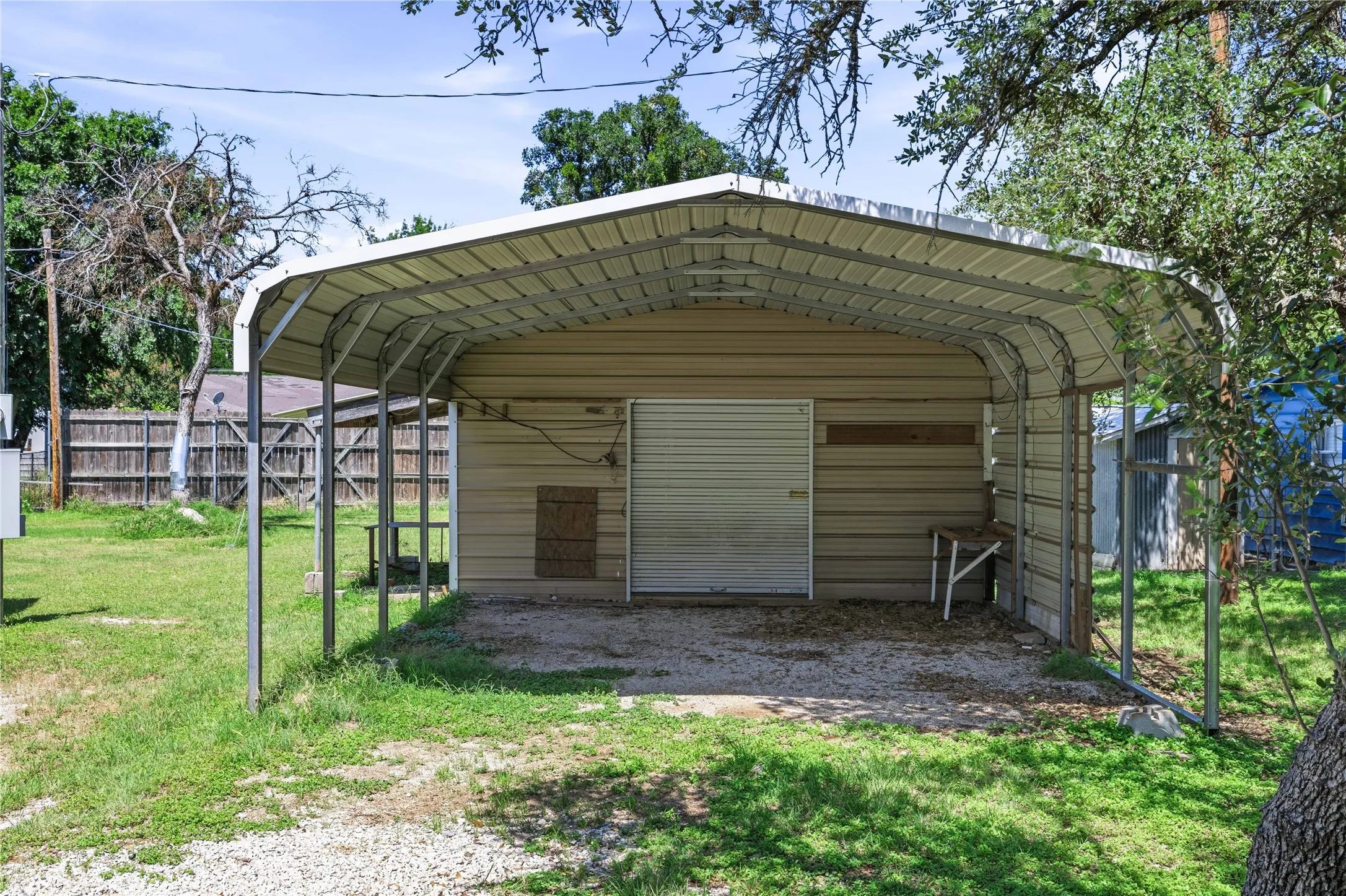 Carport # 2 with roll up door and storage area