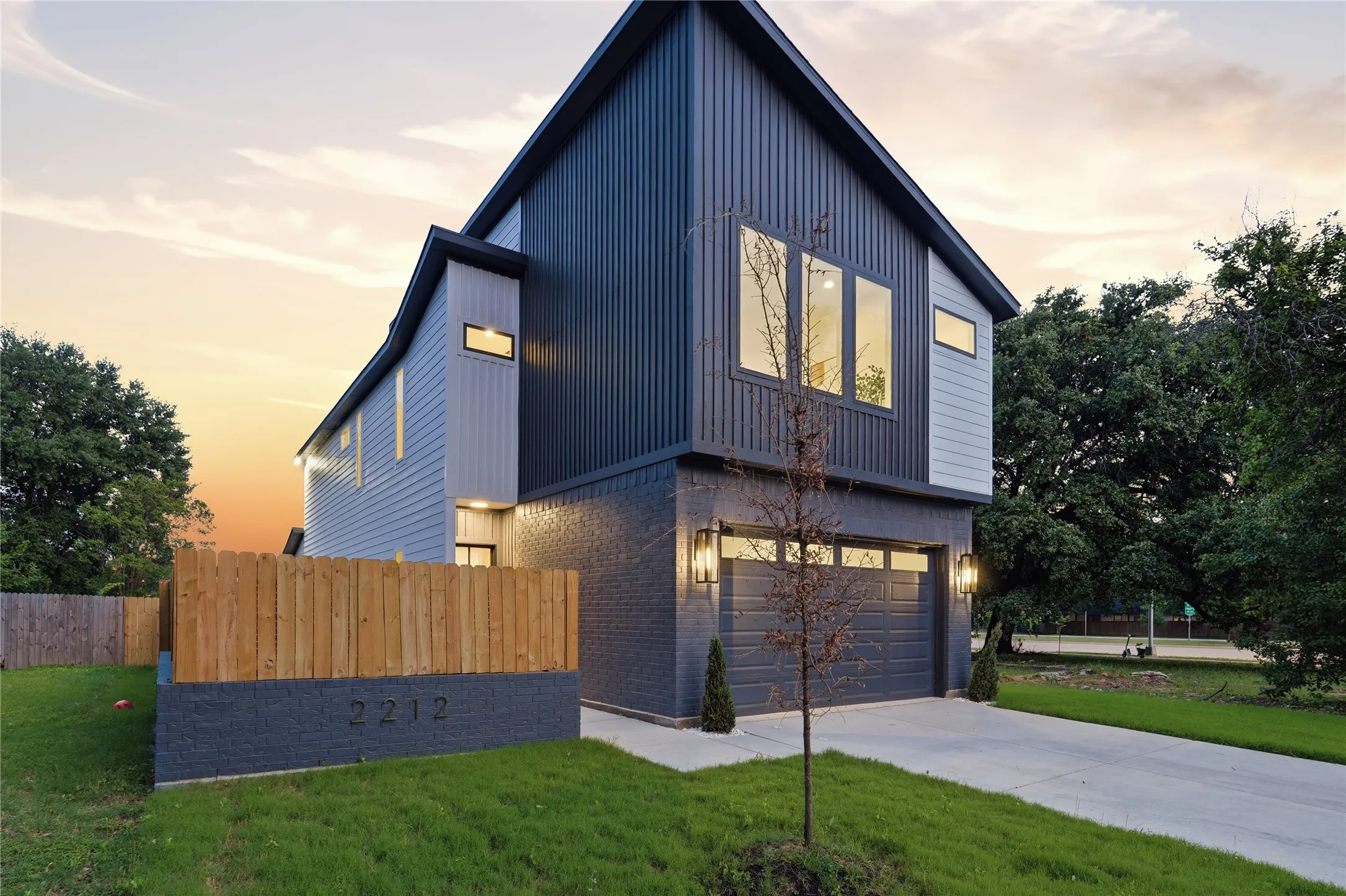 Modern architectural design featuring vertical siding accents and a contrasting brick facade