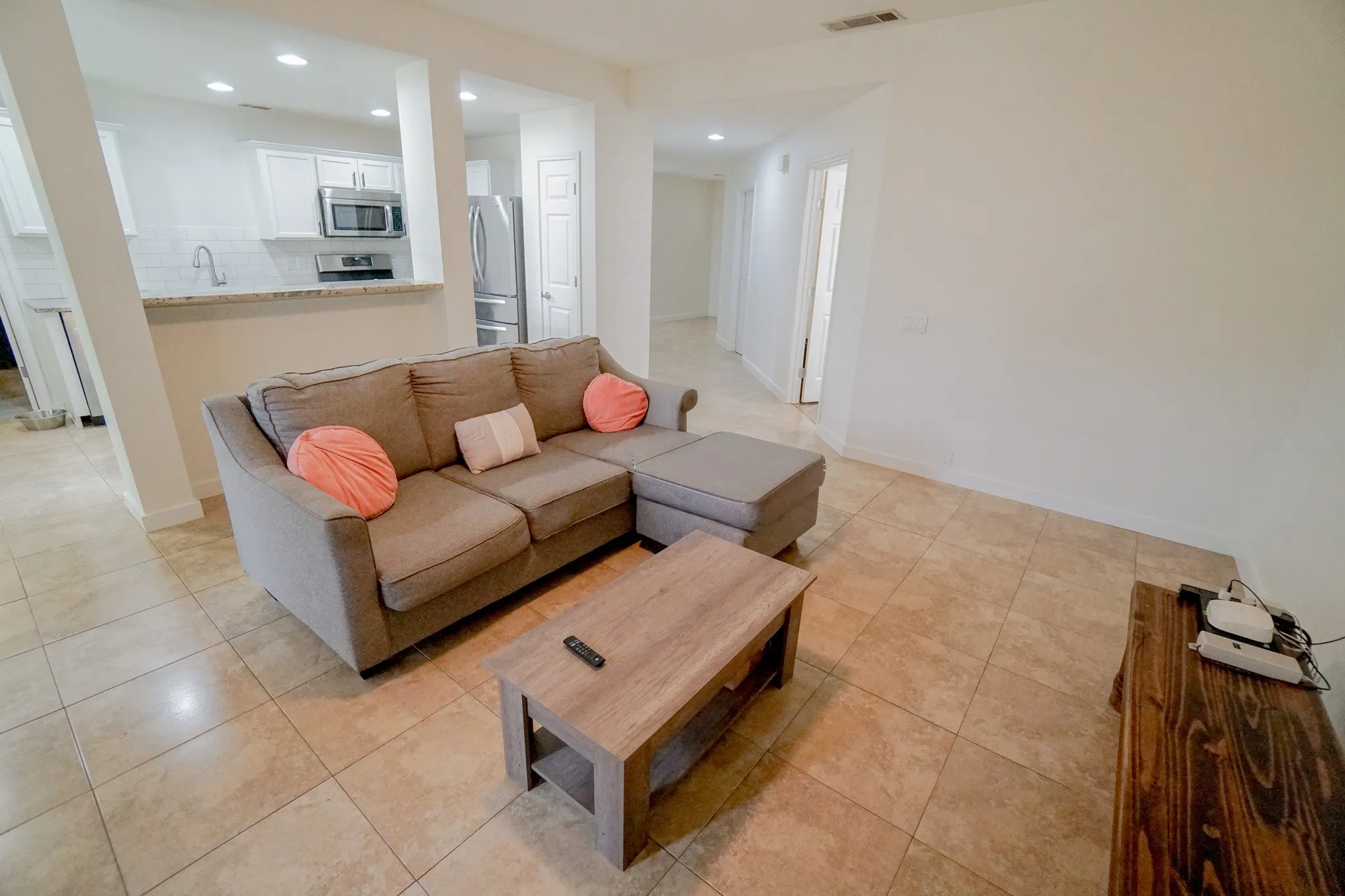 Open concept living area with light-toned tile flooring