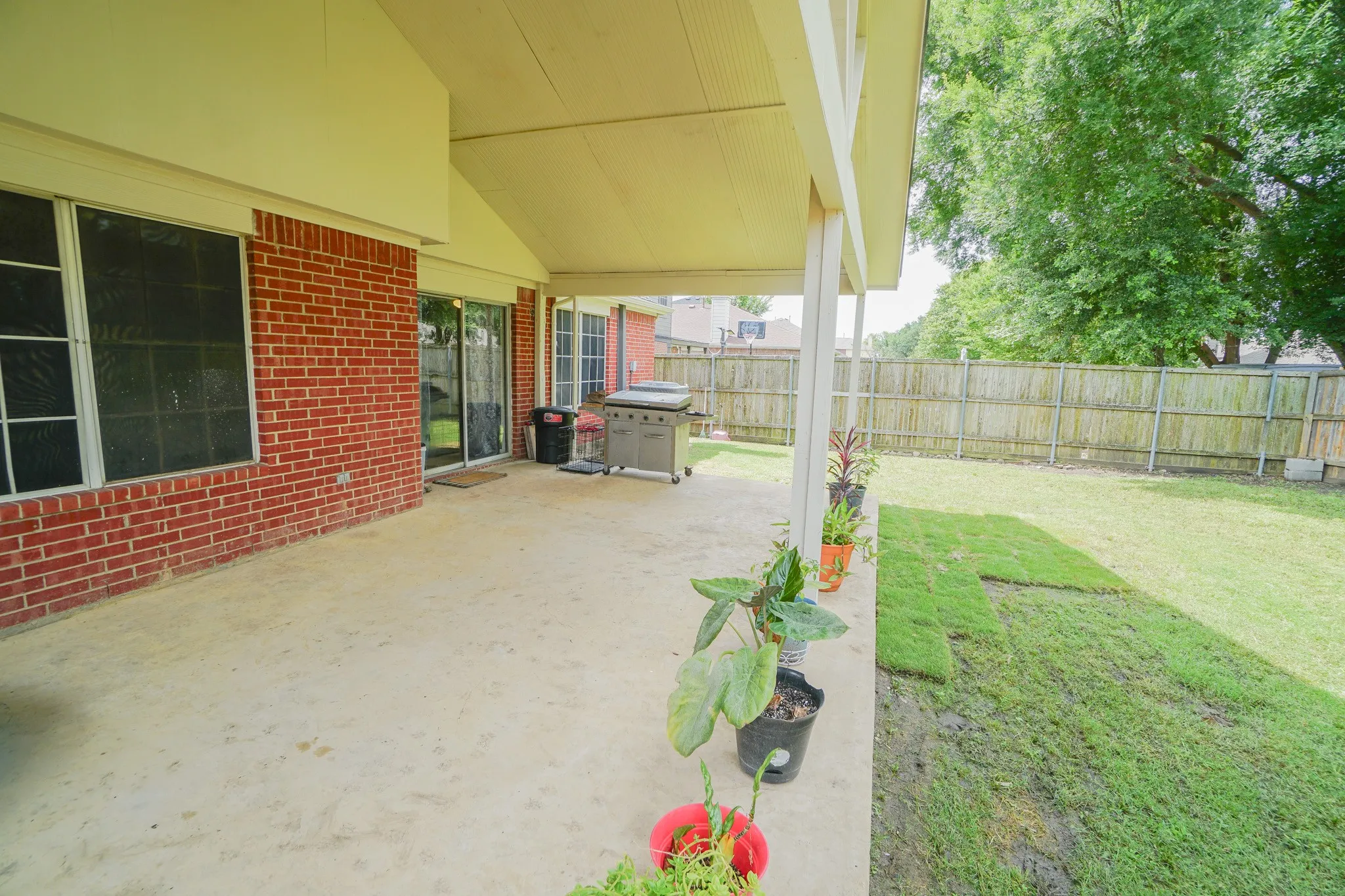 Expansive covered patio featuring a concrete surface and direct access to the backyard. 203 Grassy Creek Dr, Wylie, TX 75098