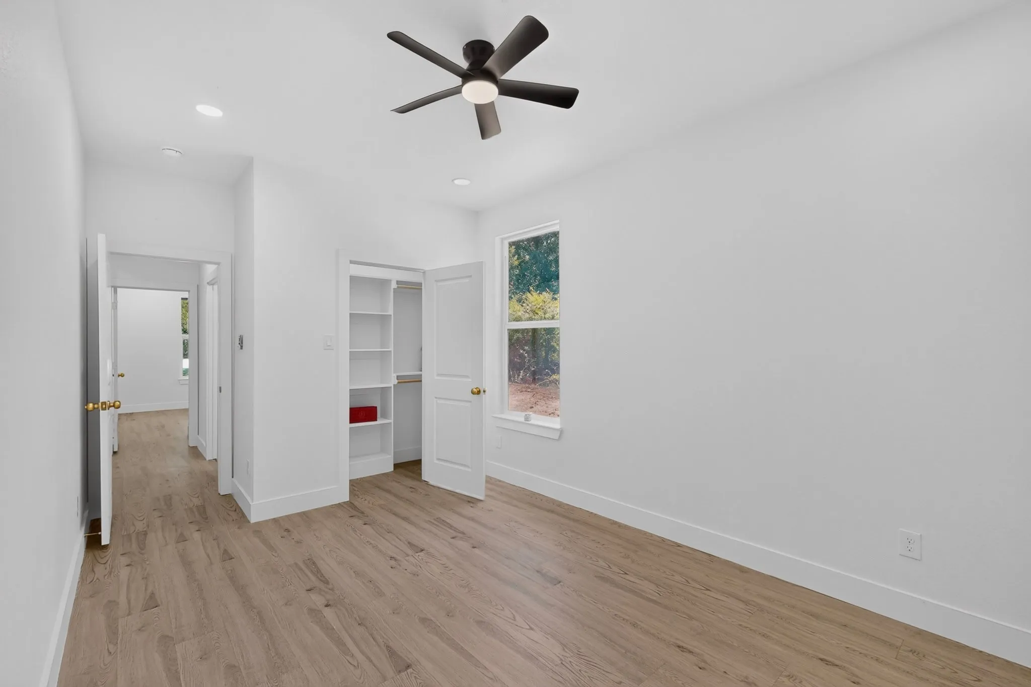 Light wood-finish flooring complements the crisp white walls and trim