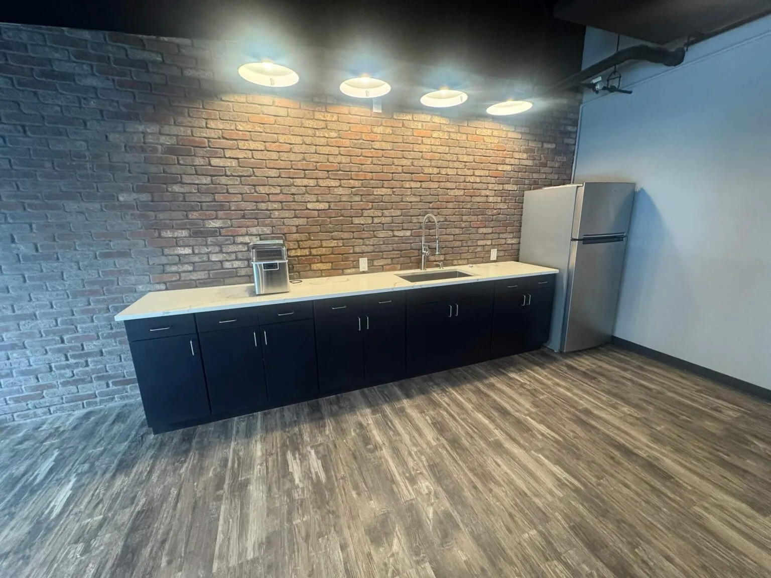 Countertop with sink and ice maker.