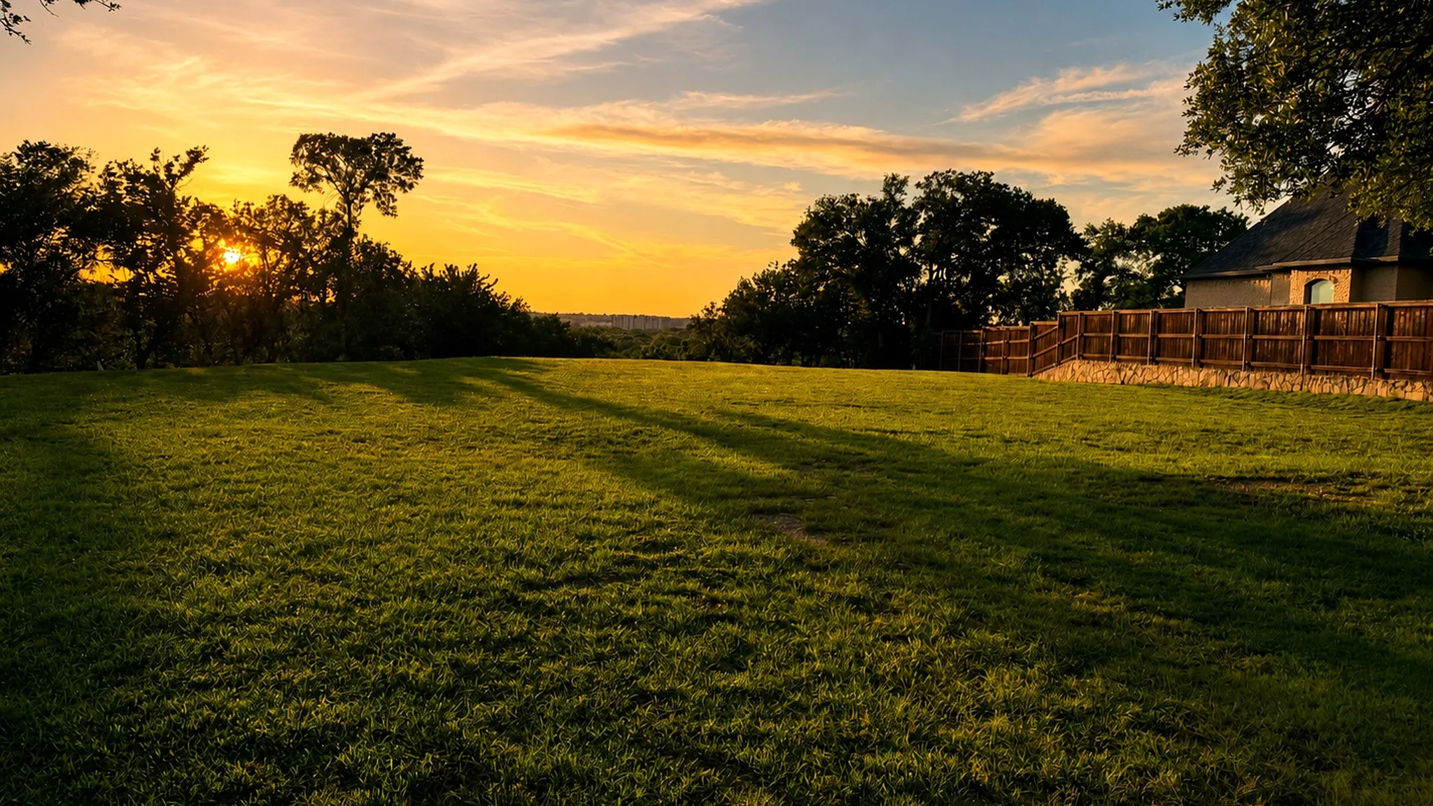 Golden-hour view across the future homesite, showcasing the lot’s elevated setting and natural beauty.