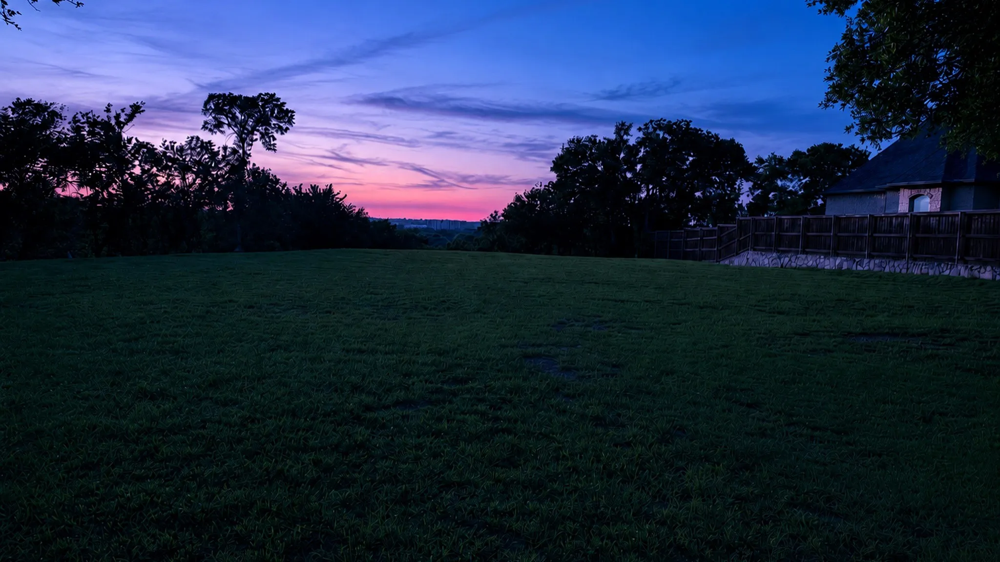 Twilight view from the homesite, capturing the peaceful elevated setting and distant skyline.
