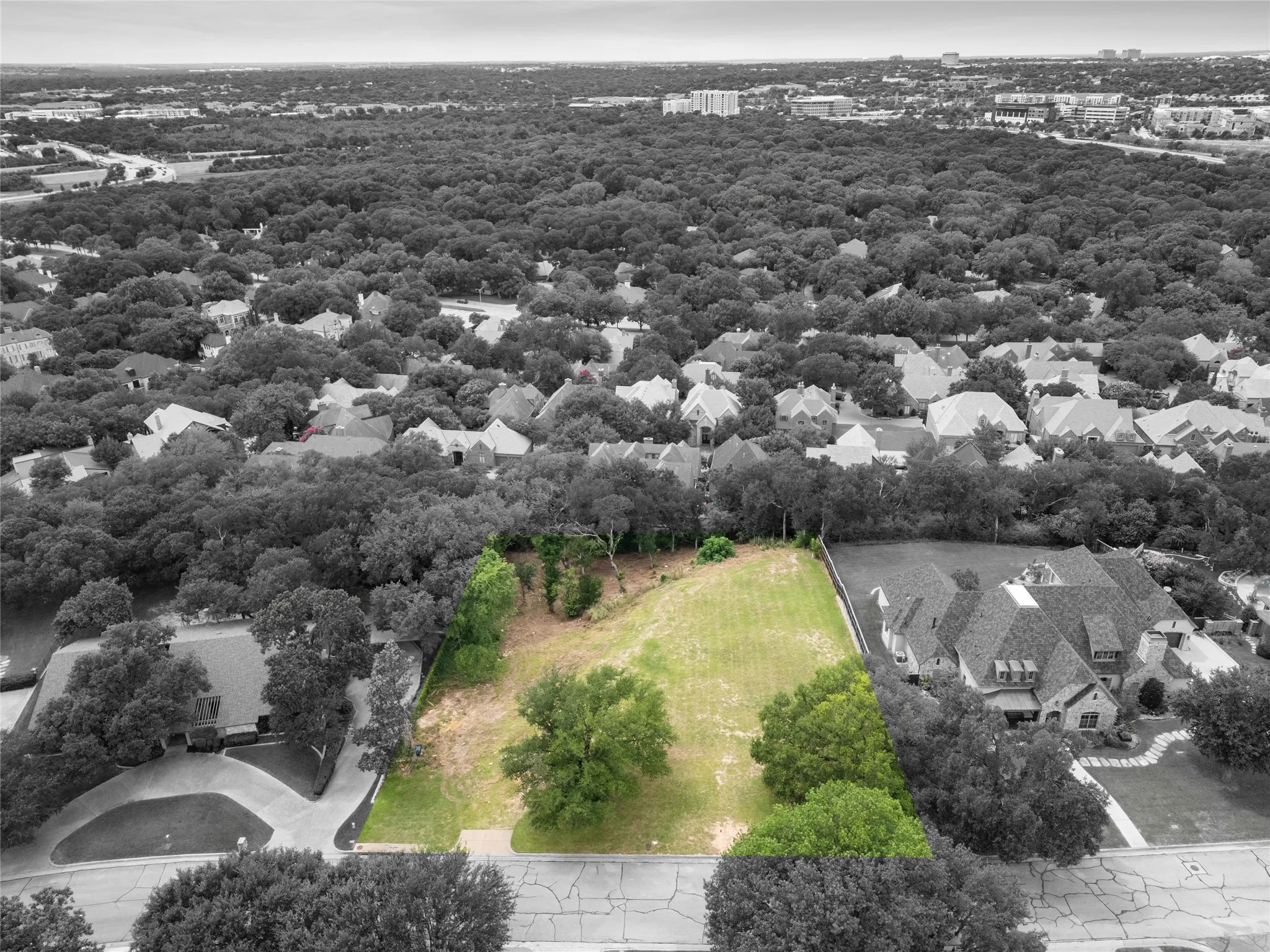 Highlighted aerial view showcases the 1.036-acre Overton West homesite, surrounding tree canopy, nearby estate homes, and elevated view-oriented setting. Highlighted area shown for visual reference only.