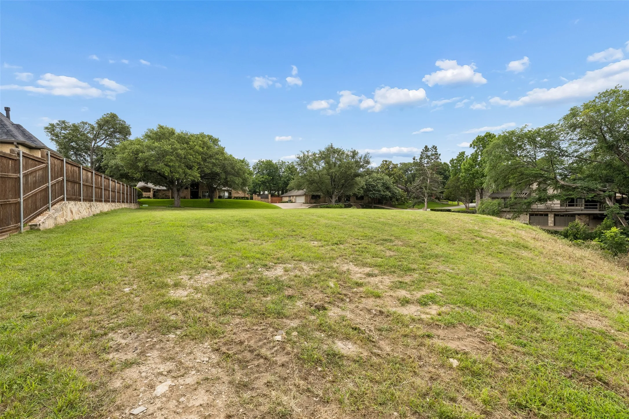 Mature trees frame the homesite and create a private, established setting with elevated views beyond the property.