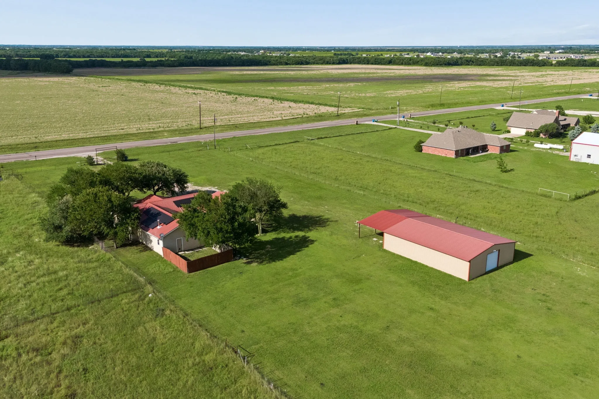 Showcasing the large 30x50 workshop located on the property with an additional room including a sink and shower.