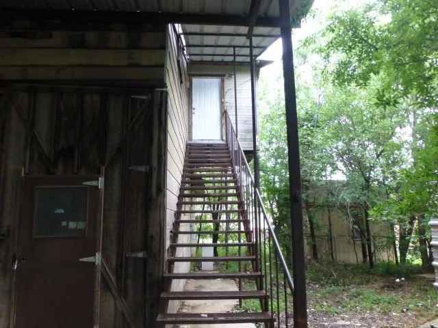 Stairs to apartment behind house