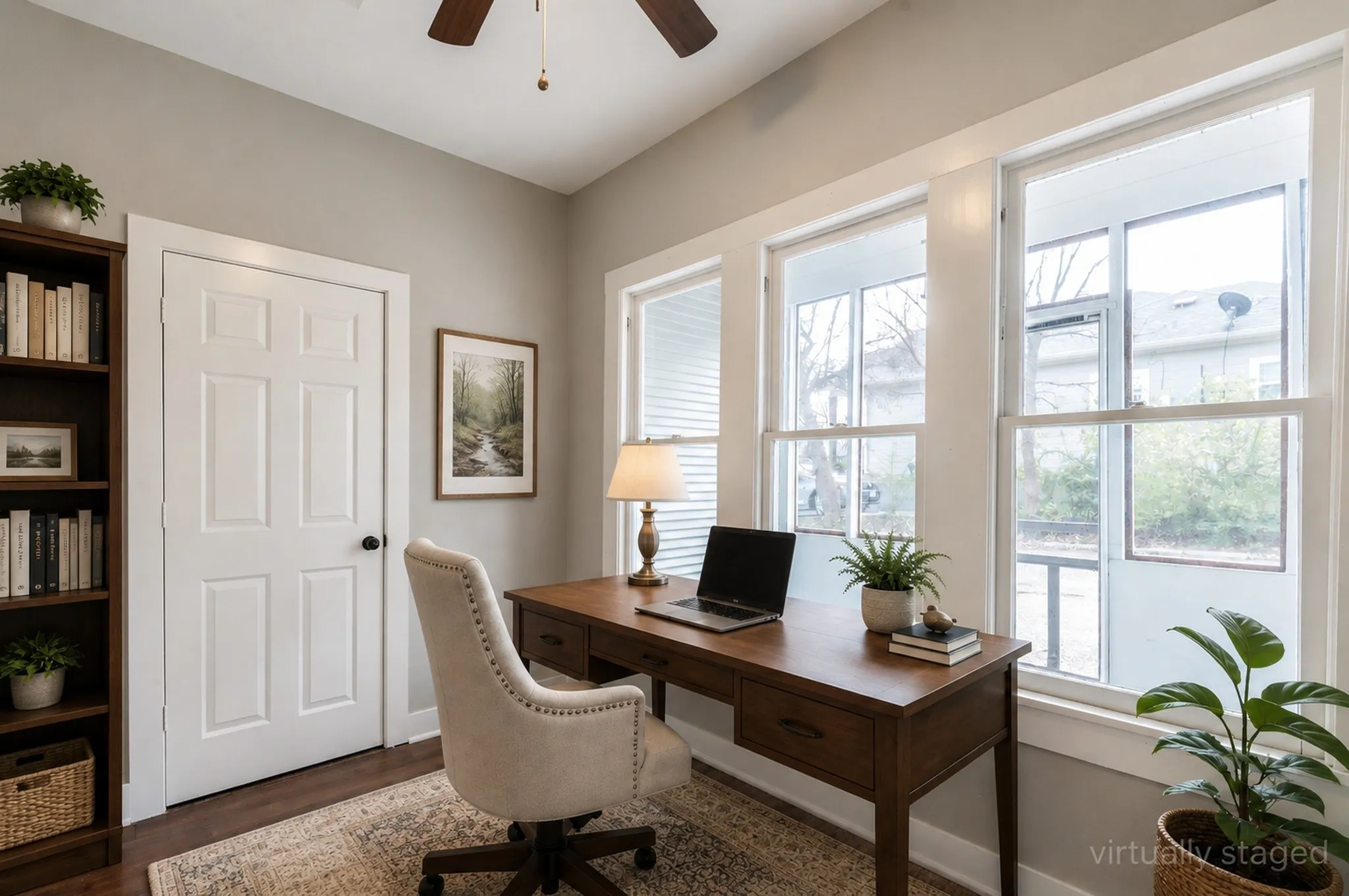 Dedicated room featuring multiple windows, wood-finish flooring, a six-panel door, and a ceiling fan