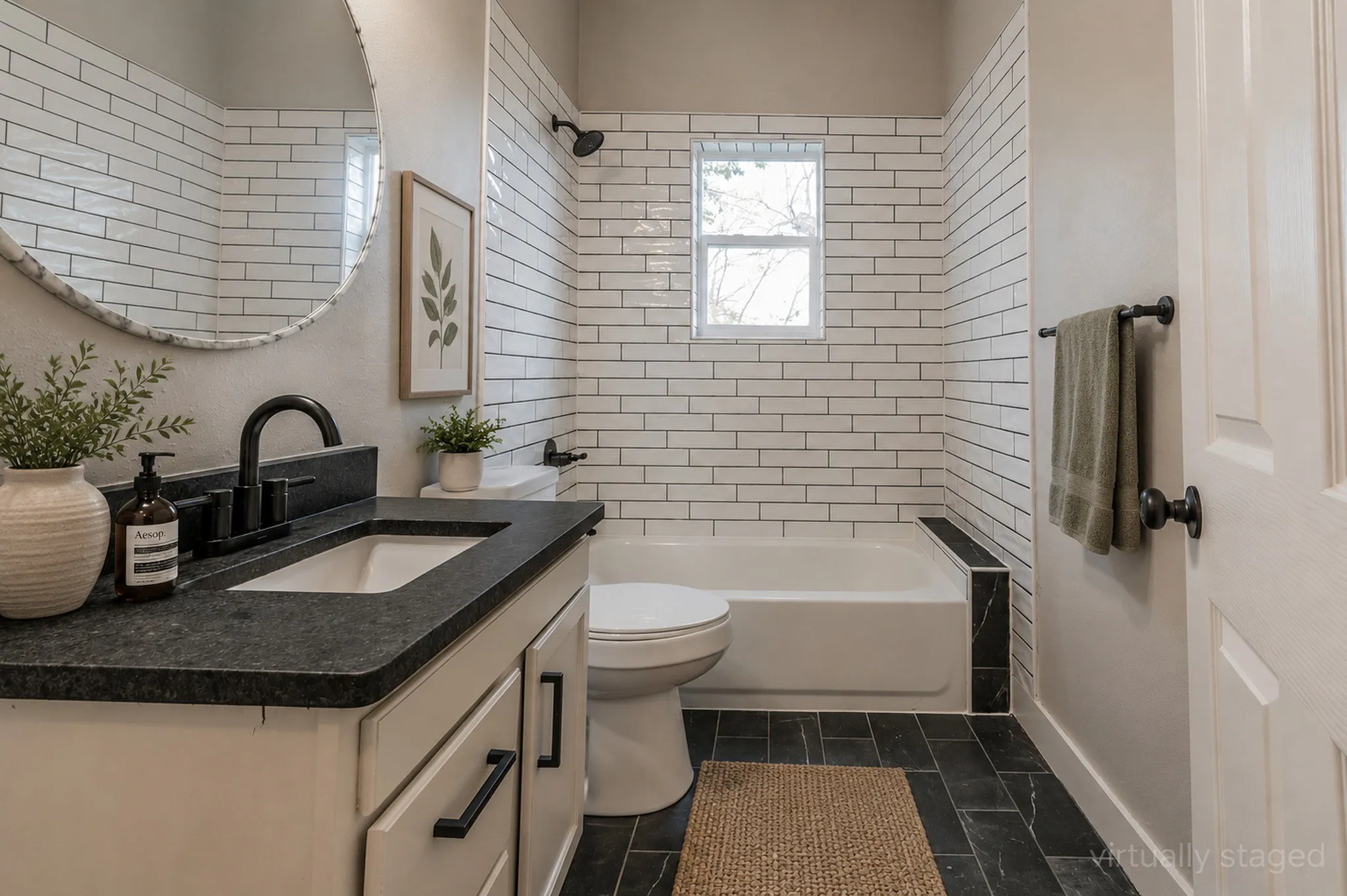 Bathroom featuring a white subway tile surround, dark stone-look flooring, and a white vanity with a dark countertop