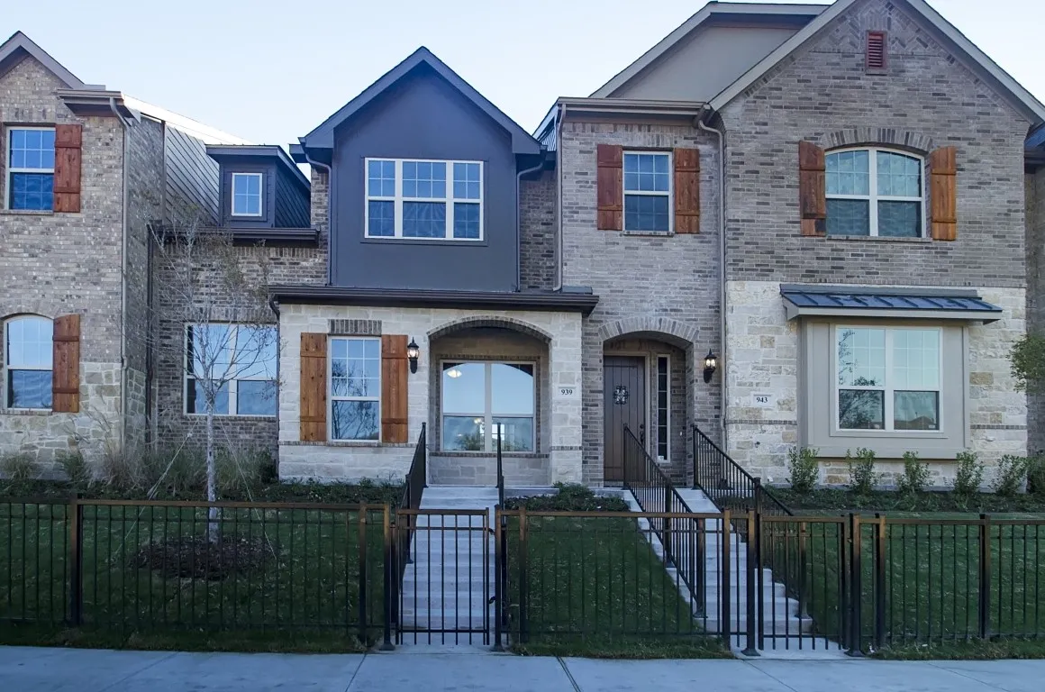 Contemporary townhouse facade featuring mixed material construction with brick and stone accents