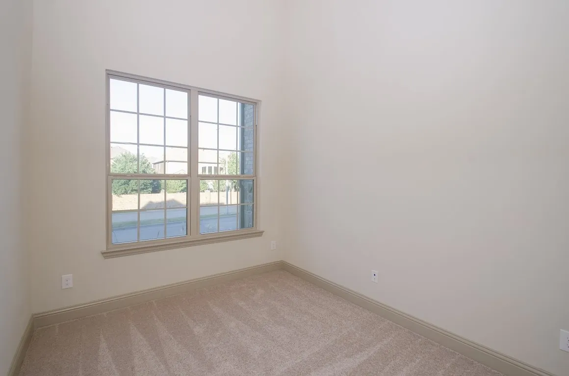 Neutral toned walls with a high ceiling
